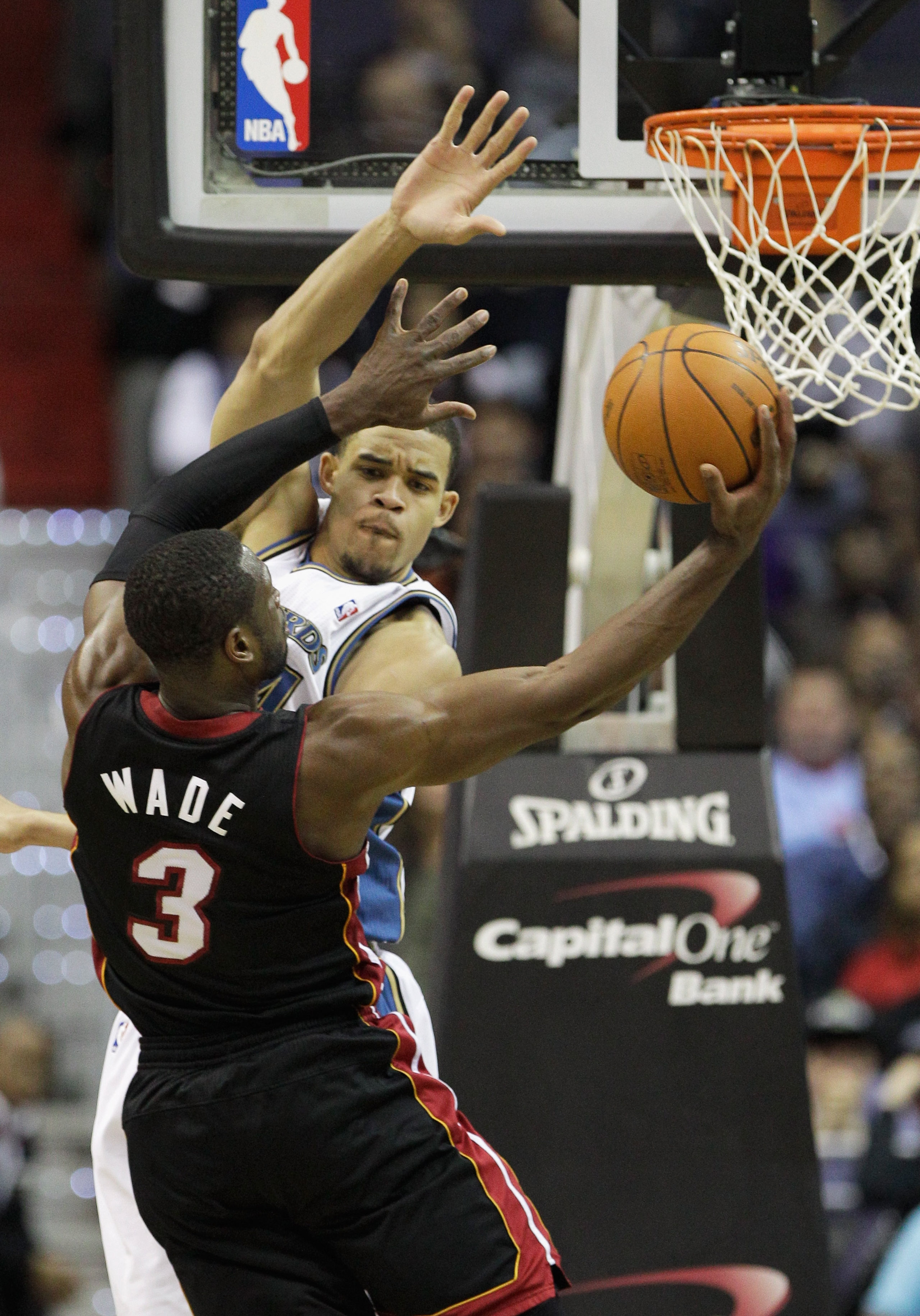 WASHINGTON, DC - MARCH 30: Dwyane Wade #3 of the Miami Heat puts up a shot against the defense of JaVale McGee #34 of the Washington Wizards during the second half at the Verizon Center on March 30, 2011 in Washington, DC. NOTE TO USER: User expressly ack