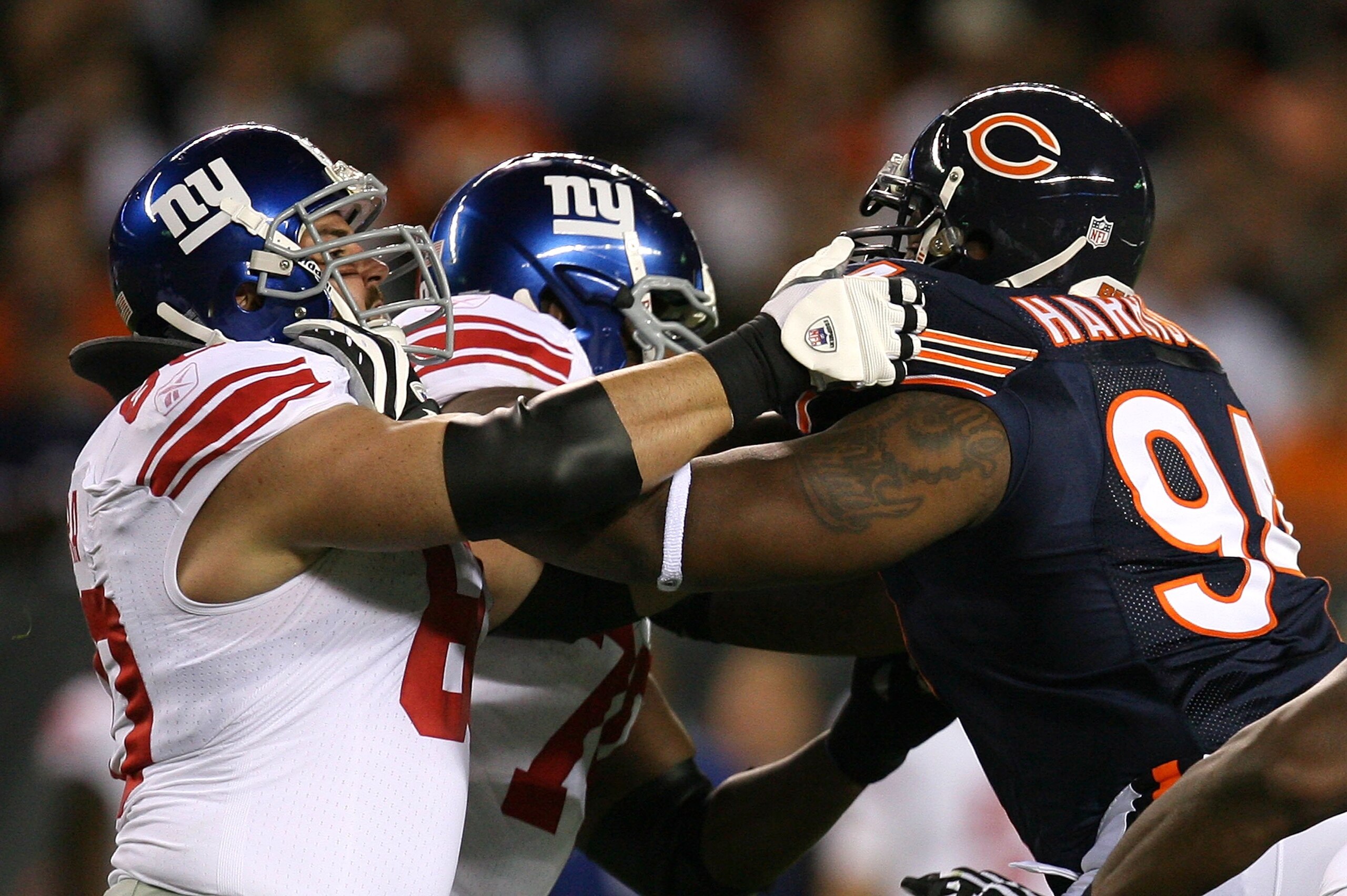 CHICAGO - AUGUST 22: Shaun O'Hara #60 of the New York Giants blocks Marcus Harrison #94 of the Chicago Bears during a pre-season game on August 22, 2009 at Soldier Field in Chicago, Illinois. The Bears defeated the Giants 17-3. (Photo by Jonathan Daniel/G