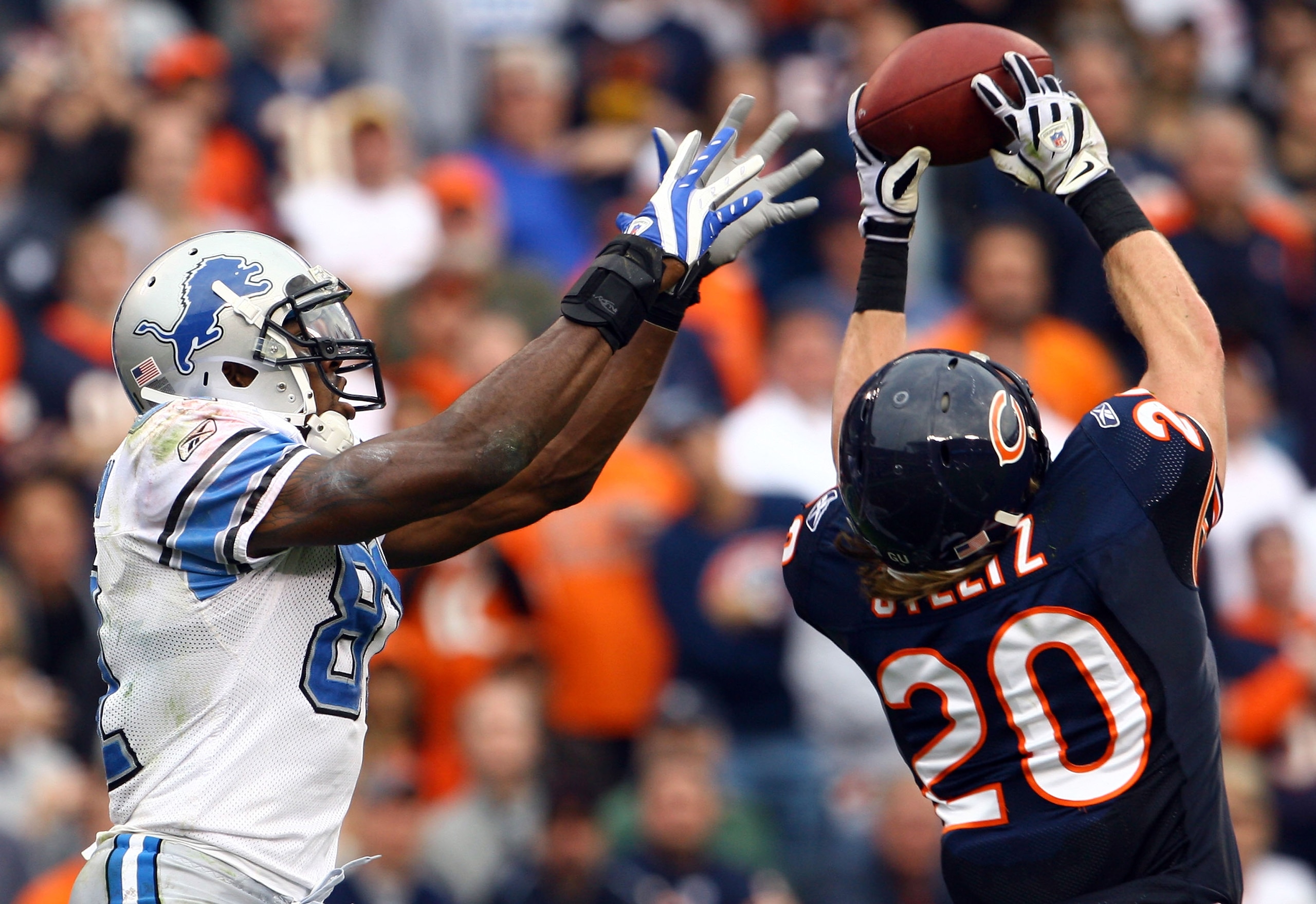 CHICAGO - NOVEMBER 02:  Craig Steltz #20 of the Chicago Bears intercepts a pass intended for Calvin Johnson #81 of the Detroit Lions during the fourth quarter at Soldier Field on November 2, 2008 in Chicago, Illinois. The Bears defeated the Lions 27-23.  