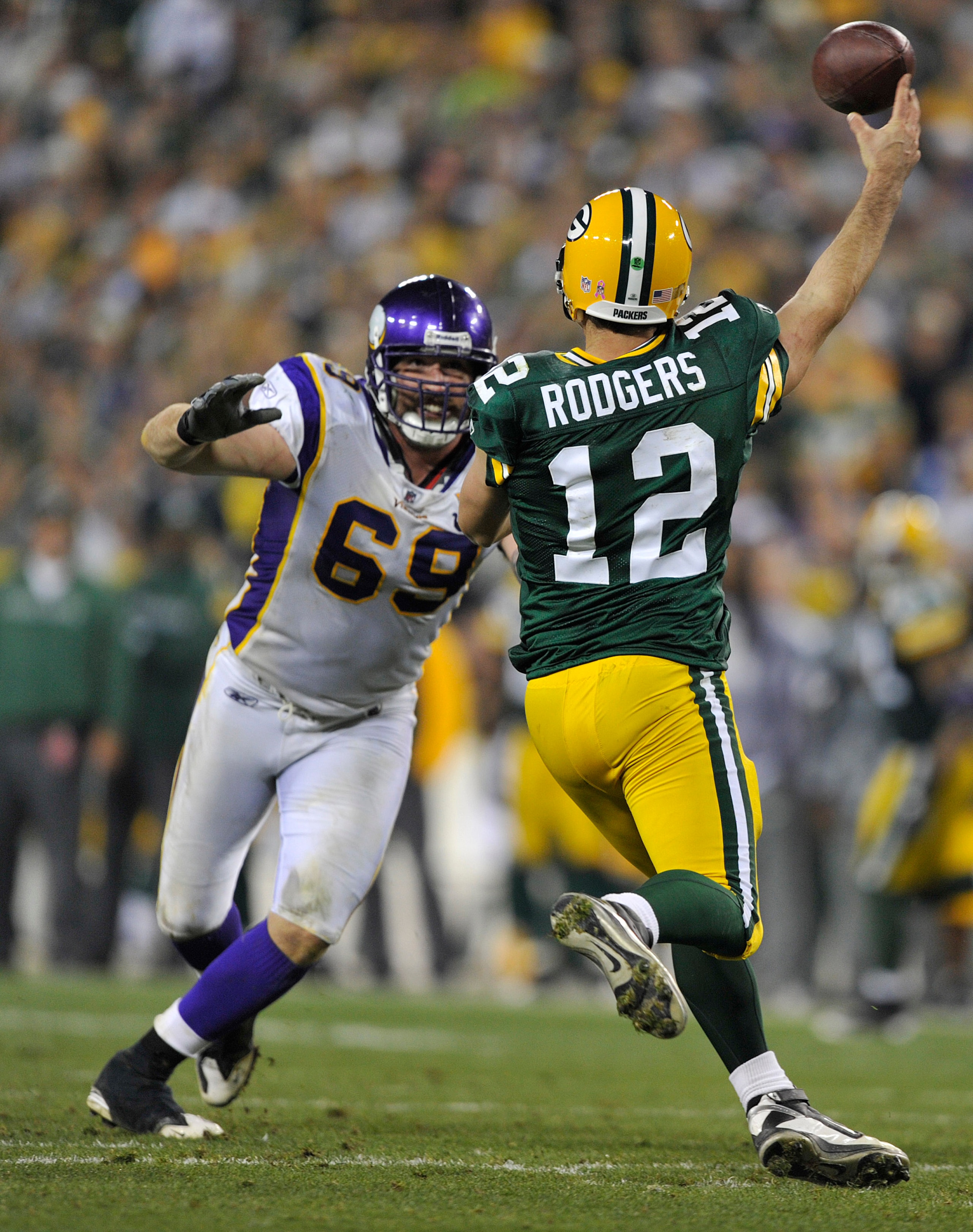GREEN BAY, WI - OCTOBER 24:  Jared Allen #69 of the Minnesota Vikings pressures Aaron Rodgers #12 of the Green Bay Packers at Lambeau Field on October 24, 2010 in Green Bay, Wisconsin. (Photo by Jim Prisching/Getty Images)