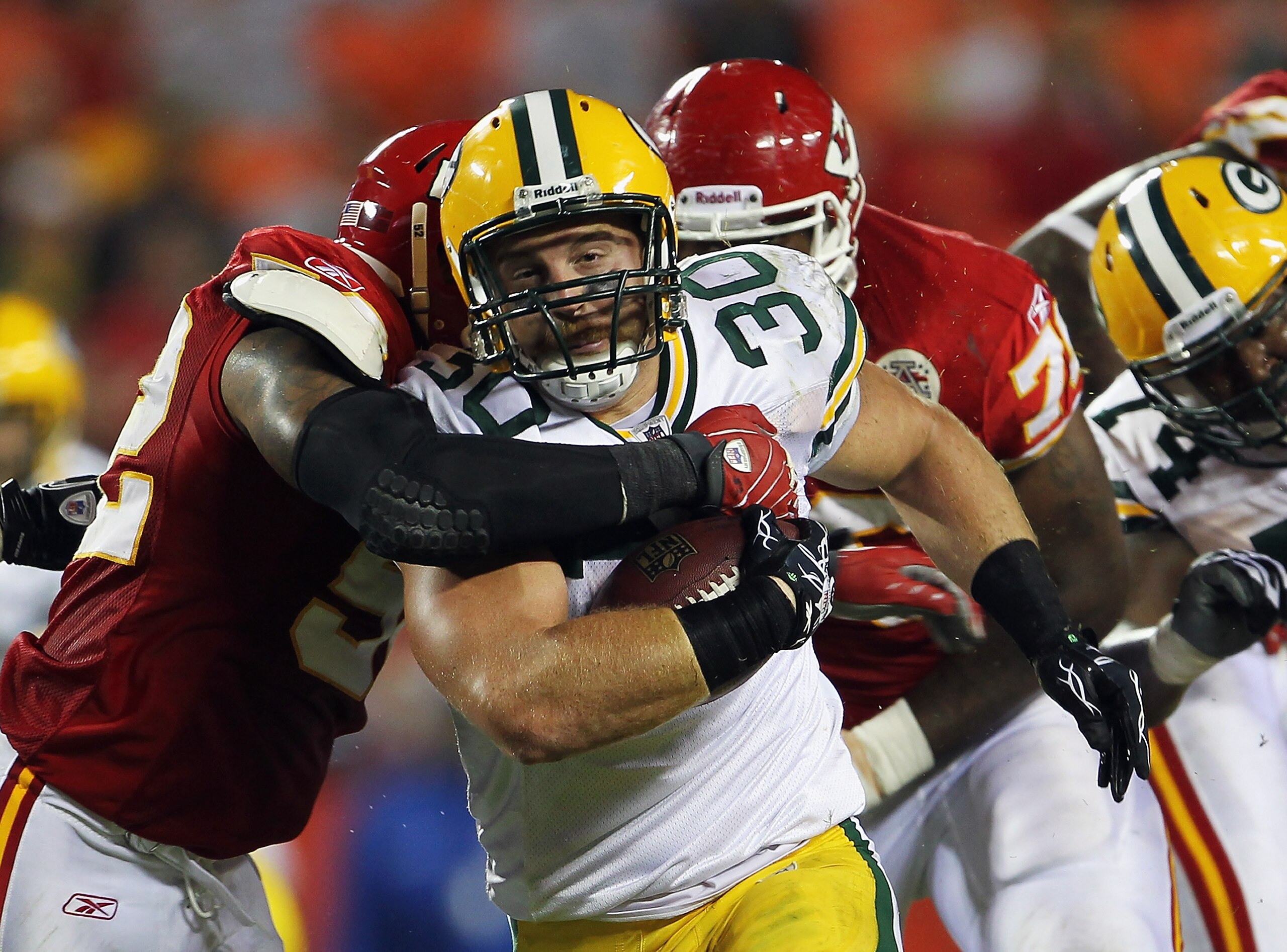 KANSAS CITY, MO - SEPTEMBER 02:  Fullback John Kuhn #30 of the Green Bay Packers carries the ball during the game against the Kansas City Chiefs on September 2, 2010 at Arrowhead Stadium in Kansas City, Missouri.  (Photo by Jamie Squire/Getty Images)