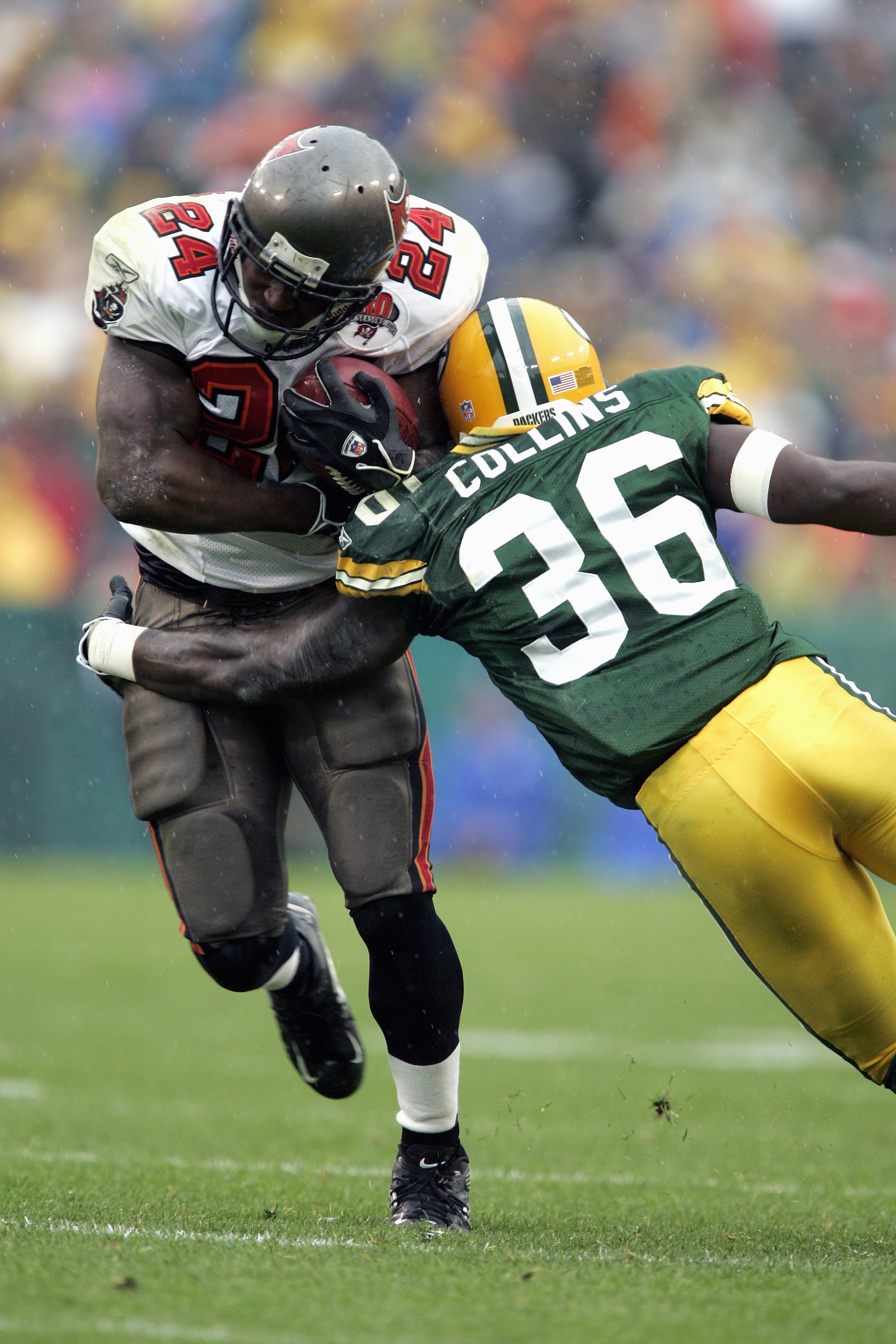GREEN BAY, WI - SEPTEMBER 25:  Joey Galloway #84 of the Tampa Bay Buccaneers carries the ball against Nick Collins #36 of the Green Bay Packers during the game on September 25, 2005 at Lambeau Field in Green Bay, Wisconsin.  The Bucs won 17-16.  (Photo by
