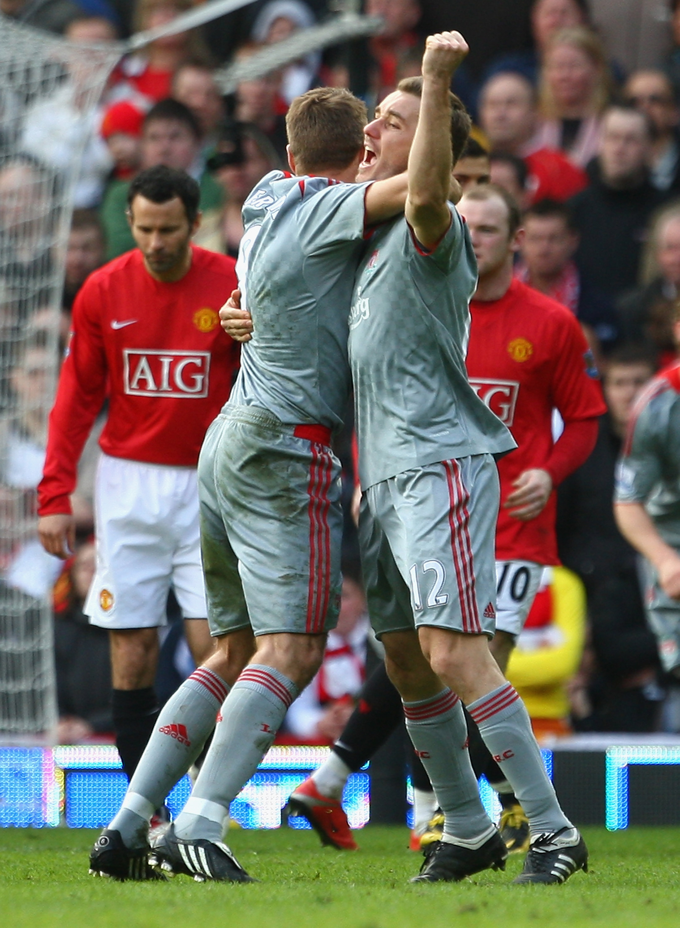 MANCHESTER, UNITED KINGDOM - MARCH 14:  Fabio Aurelio of Liverpool celebrates scoring his team's third goal with team mate Steven Gerrard during the Barclays Premier League match between Manchester United and Liverpool at Old Trafford on March 14, 2009 in