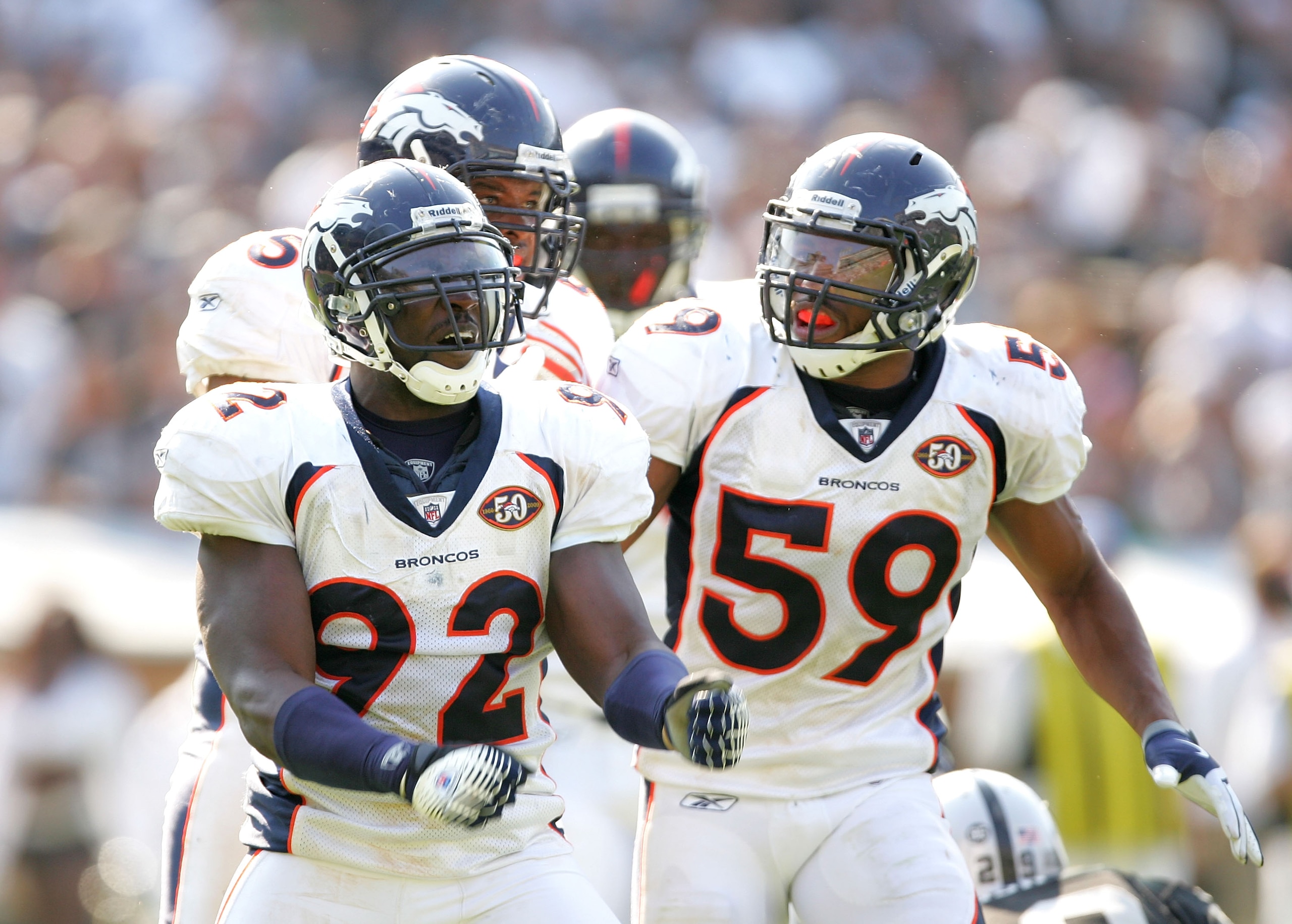 OAKLAND, CA - SEPTEMBER 27:   Wesley Woodyard #59 congratulates Elvis Dumervil #92 of the Denver Broncos after Dumervil sacked JaMarcus Russell of the Oakland Raiders at the Oakland-Alameda County Coliseum on September 27, 2009 in Oakland, California.  (P