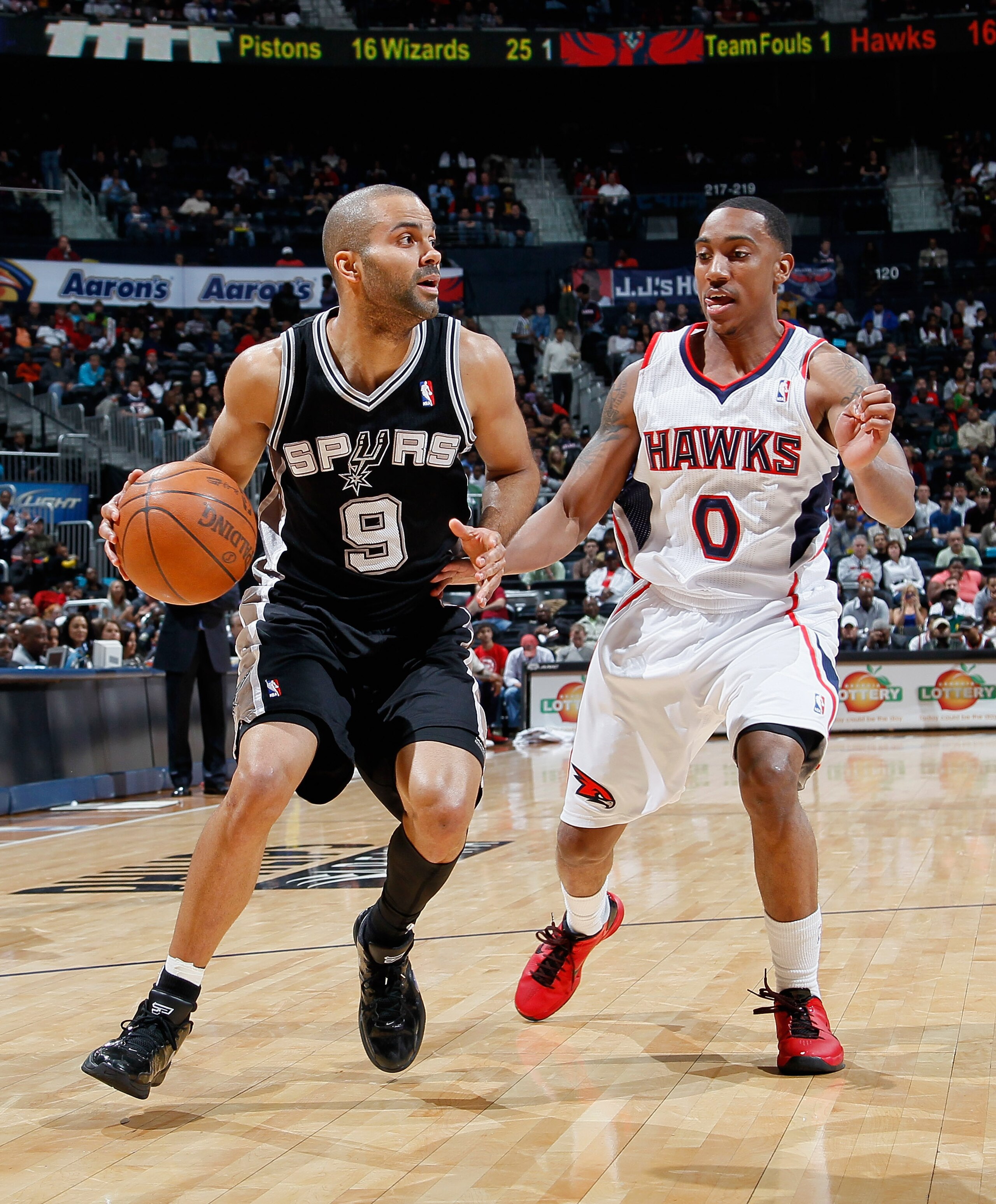 ATLANTA, GA - APRIL 05:  Tony Parker #9 of the San Antonio Spurs against Jeff Teague #0 of the Atlanta Hawks at Philips Arena on April 5, 2011 in Atlanta, Georgia.  NOTE TO USER: User expressly acknowledges and agrees that, by downloading and/or using thi
