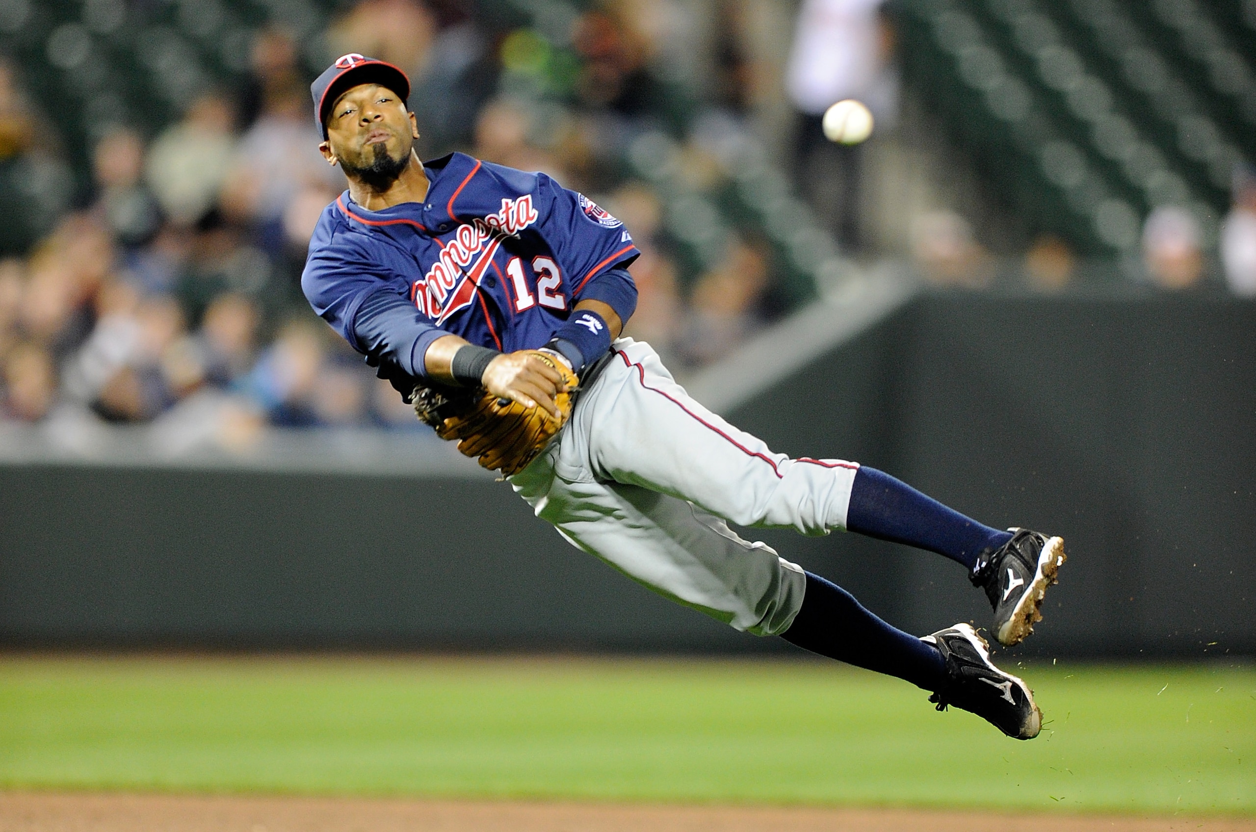 BALTIMORE, MD - APRIL 18:  Alexi Casilla #12 of the Minnesota Twins throws the ball to first base against the Baltimore Orioles at Oriole Park at Camden Yards on April 18, 2011 in Baltimore, Maryland.  (Photo by Greg Fiume/Getty Images)