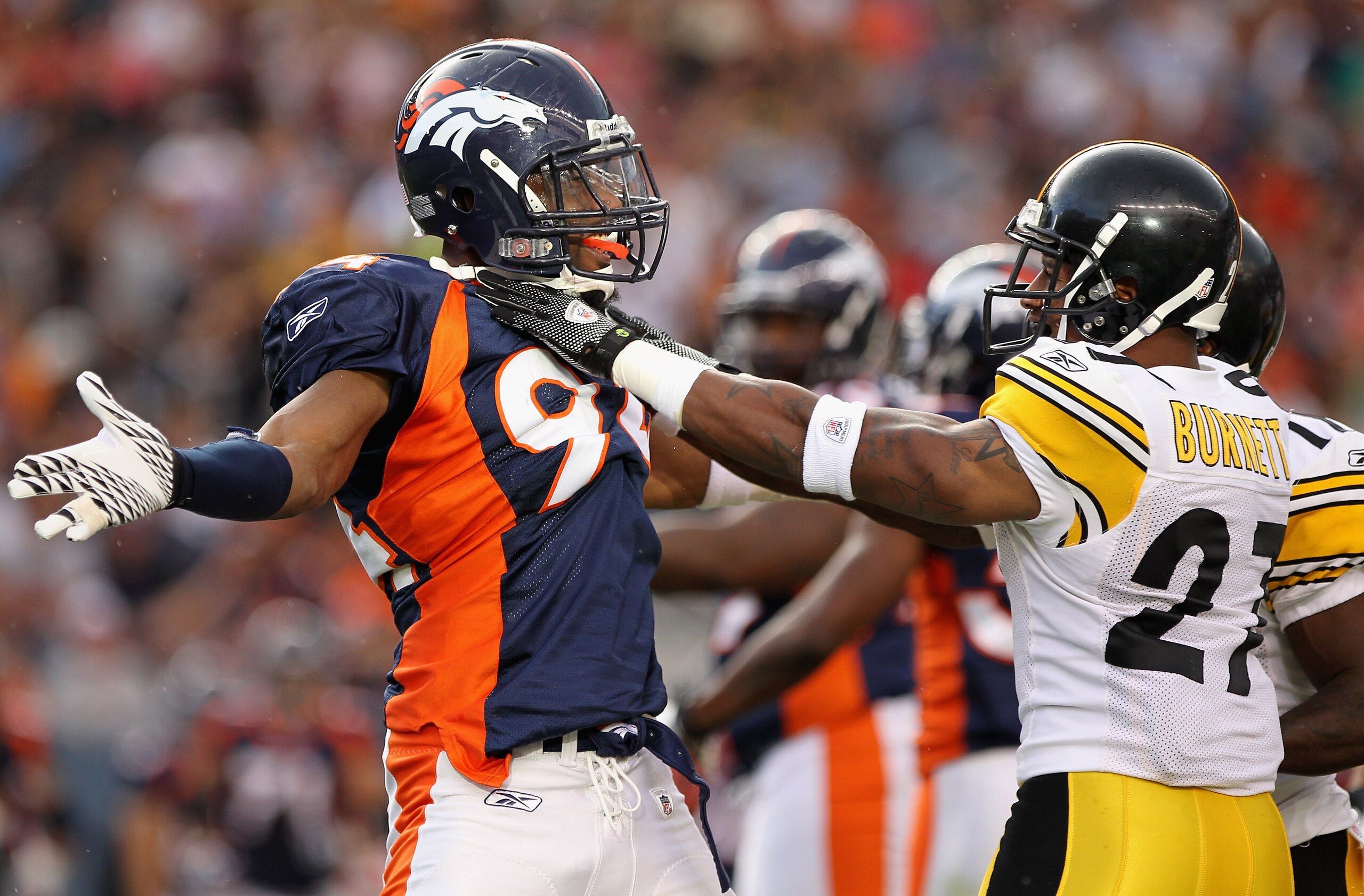 DENVER - AUGUST 29: Linebacker Jarvis Moss #94 of the Denver Broncos and cornerback Joe Burnett #27 of the Pittsburgh Steelers mix it up during preseason NFL action at INVESCO Field at Mile High on August 29, 2010 in Denver, Colorado. (Photo by Doug Pen DENVER - AUGUST 29: Linebacker Jarvis Moss #94 of the Denver Broncos and cornerback Joe Burnett #27 of the Pittsburgh Steelers mix it up during preseason NFL action at INVESCO Field at Mile High on August 29, 2010 in Denver, Colorado. (Photo by Doug Pen