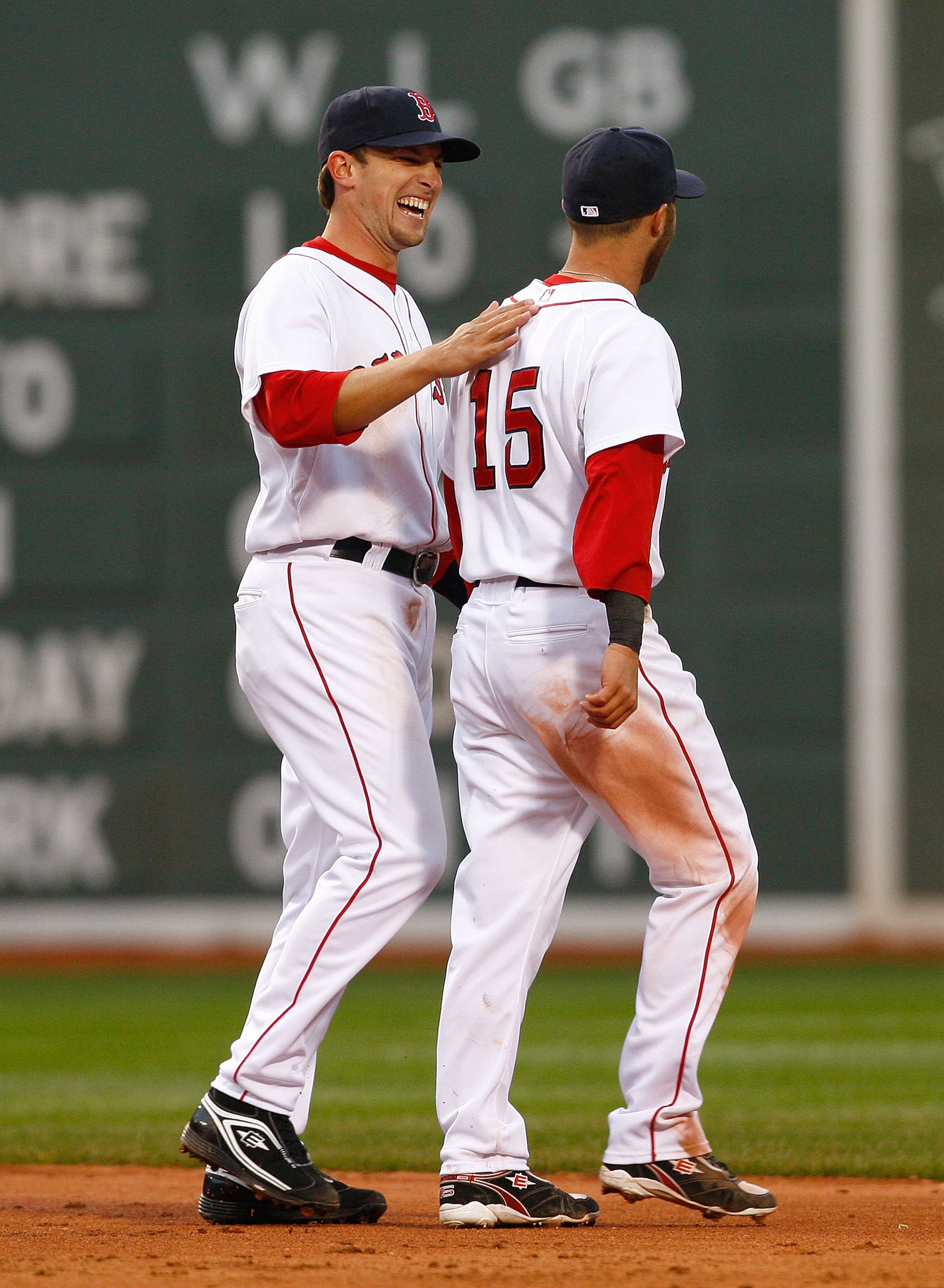 BOSTON - APRIL 7: Jed Lowrie #12 and Justin Pedroia #15 of the Boston Red Sox celebrate after defeating the Tampa Bay Rays, 5-3, at Fenway Park April 7, 2009 in Boston, Massachusetts. (Photo by Jim Rogash/Getty Images)