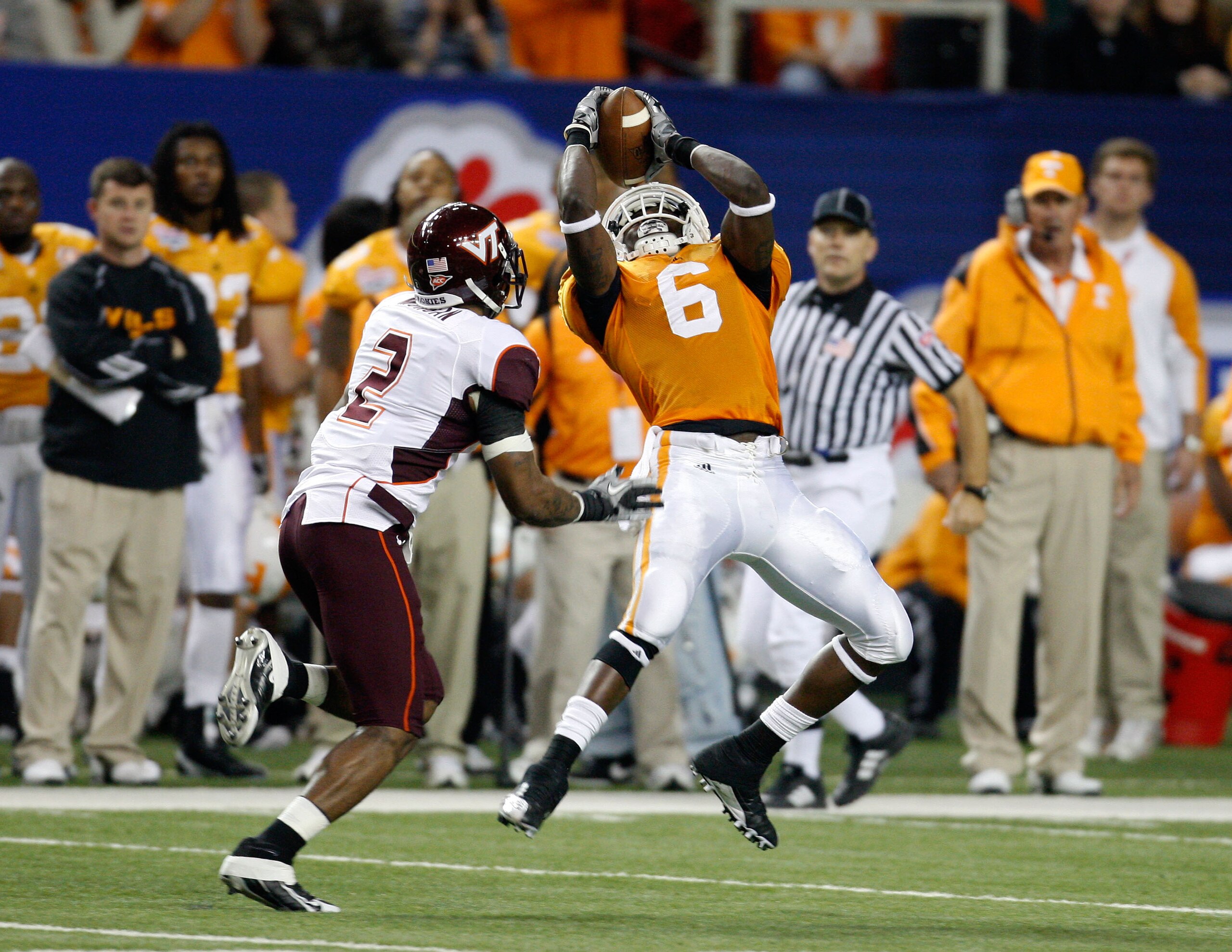 ATLANTA - DECEMBER 31:  Wide receiver Denarius Moore #6 of the Tennessee Volunteers hauls in a second quarter pass while defensive back Devon Morgan #2 of the Virginia Tech Hokies tries to cover him during the Chick-Fil-A Bowl at the Georgia Dome on Decem