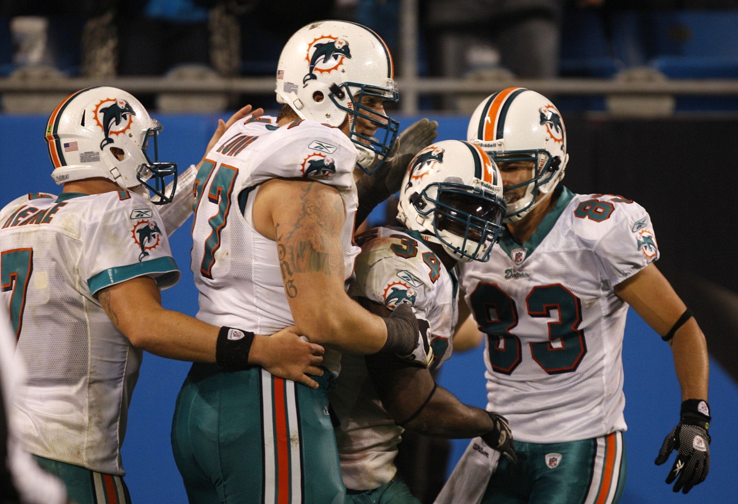 CHARLOTTE - NOVEMBER 19: (L-R) Chad Henne #7 Jake Long #77, Ricky Williams #34 and Greg Camarillo #83 of the Miami Dolphins celebrate after Williams scored a 46 yard rushing touchdown against the Carolina Panthers at Bank of America Stadium on November 19 CHARLOTTE - NOVEMBER 19: (L-R) Chad Henne #7 Jake Long #77, Ricky Williams #34 and Greg Camarillo #83 of the Miami Dolphins celebrate after Williams scored a 46 yard rushing touchdown against the Carolina Panthers at Bank of America Stadium on November 19