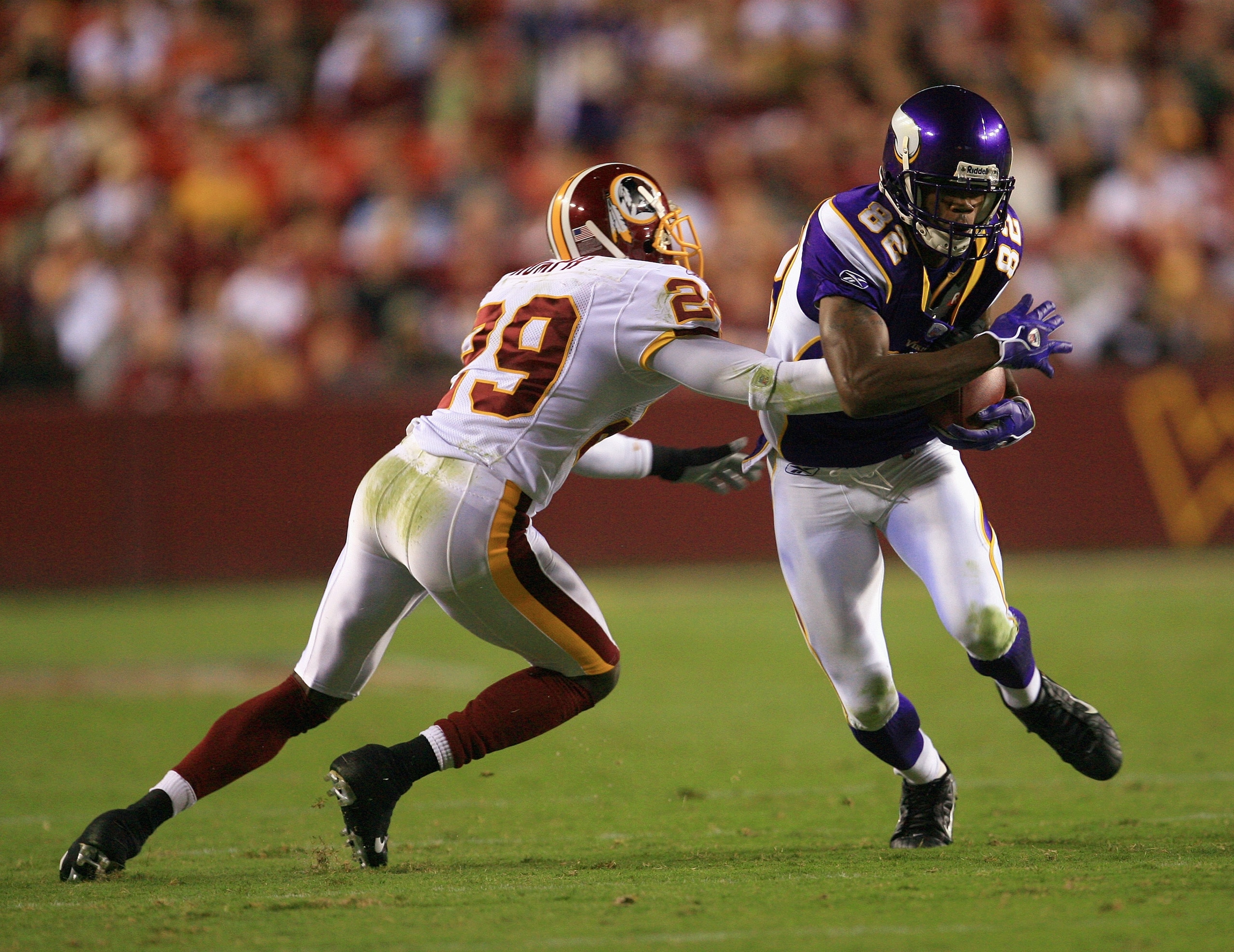 LANDOVER, MD - SEPTEMBER 11: Troy Williamson #82 of the Minnesota Vikings runs the ball under pressure from Mike Rumph #29 of the Washington Redskins on the first Monday Night Football game of the season on September 11, 2006 at FedEx Field in Landover, M LANDOVER, MD - SEPTEMBER 11: Troy Williamson #82 of the Minnesota Vikings runs the ball under pressure from Mike Rumph #29 of the Washington Redskins on the first Monday Night Football game of the season on September 11, 2006 at FedEx Field in Landover, M