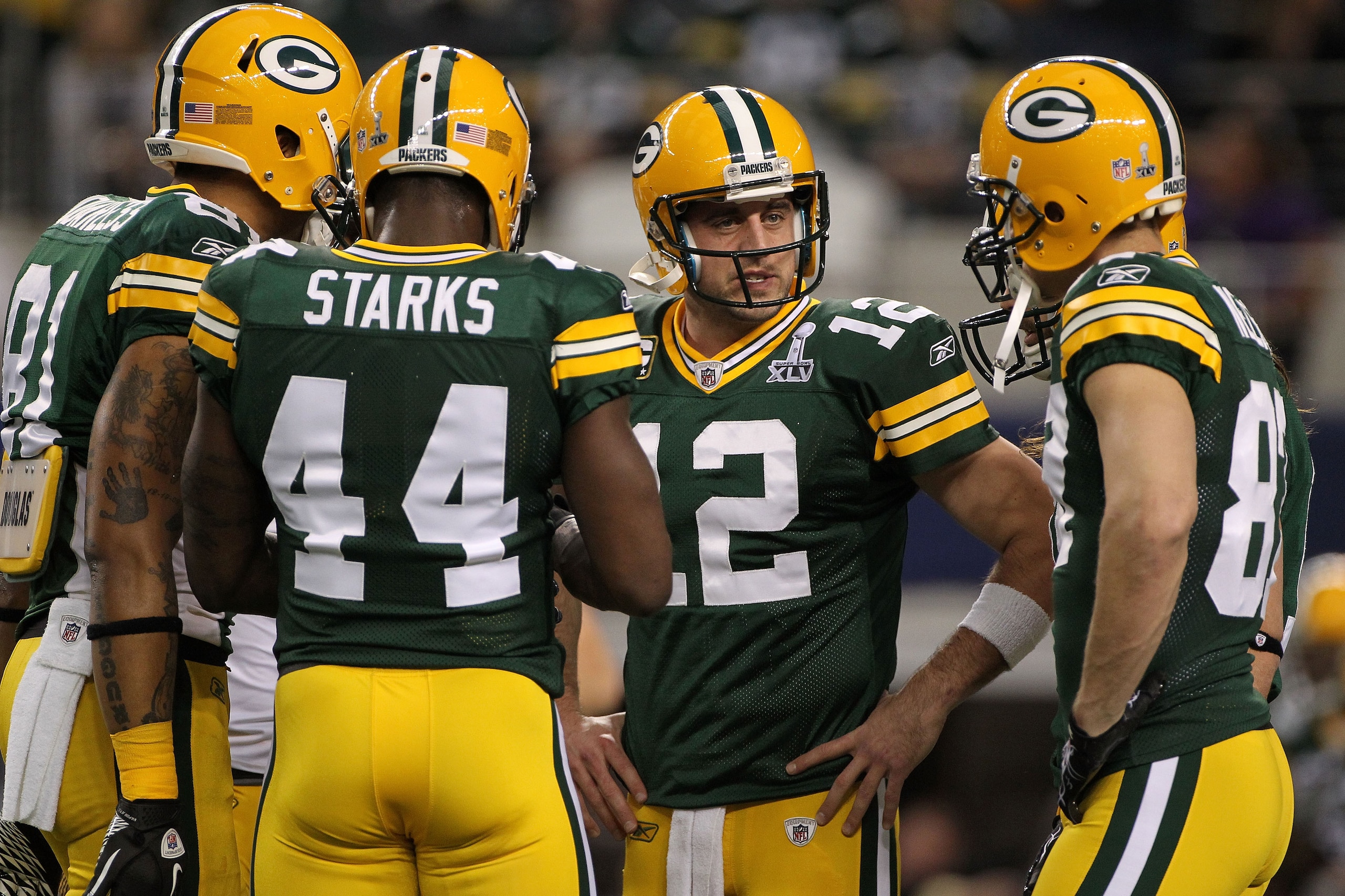 ARLINGTON, TX - FEBRUARY 06:  Aaron Rodgers #12 of the Green Bay Packers talks to teammates prior to their game against the Pittsburgh Steelers during Super Bowl XLV at Cowboys Stadium on February 6, 2011 in Arlington, Texas.  (Photo by Doug Pensinger/Get
