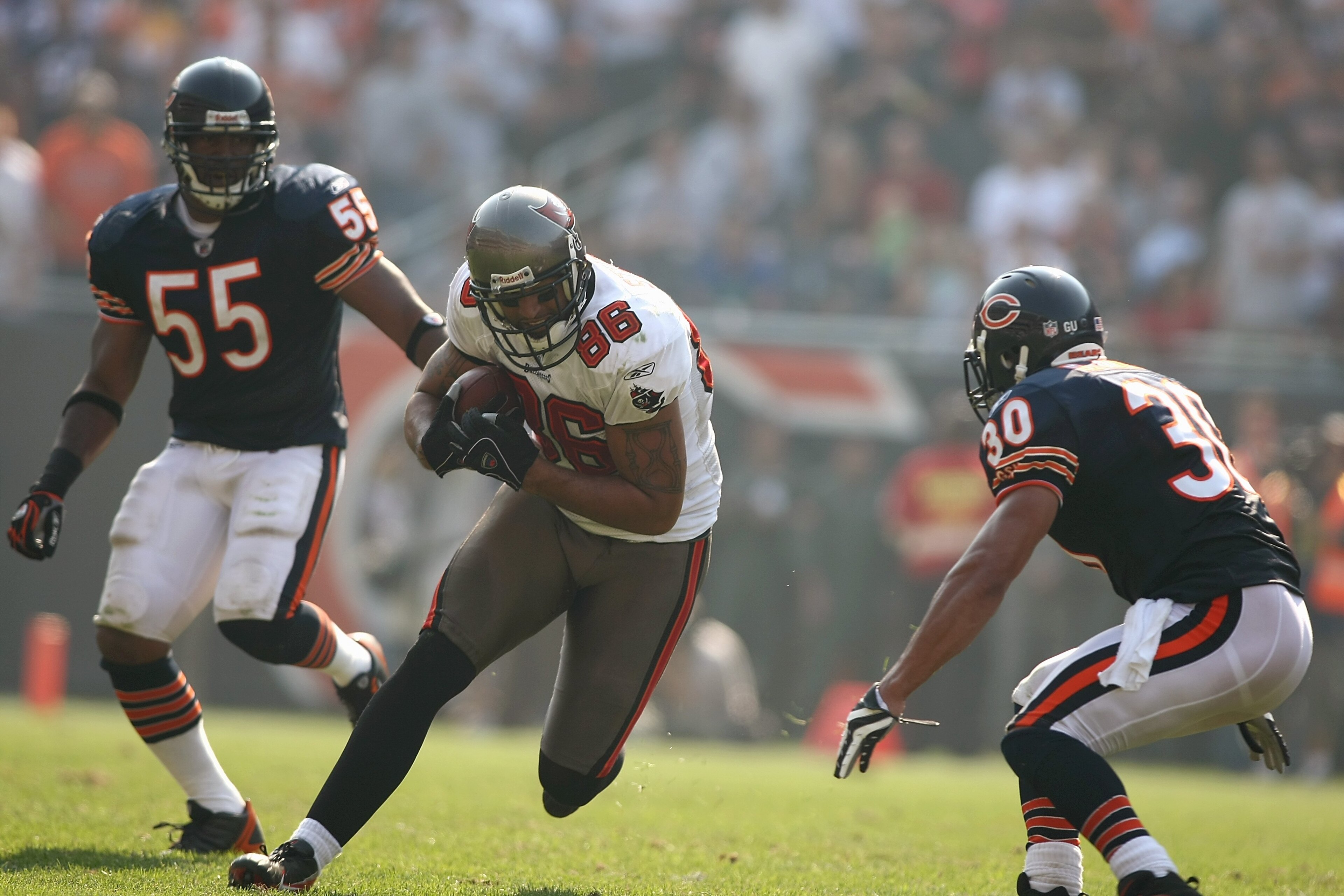 CHICAGO - SEPTEMBER 21: Jerramy Stevens #86 of the Tampa Bay Buccaneers runs with the ball against Mike Brown #30 of the Chicago Bears at Soldier Field on September 21, 2008 in Chicago, Illinois. The Buccaneers won 27-24 in OT. (Photo by Jonathan Ferrey/ CHICAGO - SEPTEMBER 21: Jerramy Stevens #86 of the Tampa Bay Buccaneers runs with the ball against Mike Brown #30 of the Chicago Bears at Soldier Field on September 21, 2008 in Chicago, Illinois. The Buccaneers won 27-24 in OT. (Photo by Jonathan Ferrey/