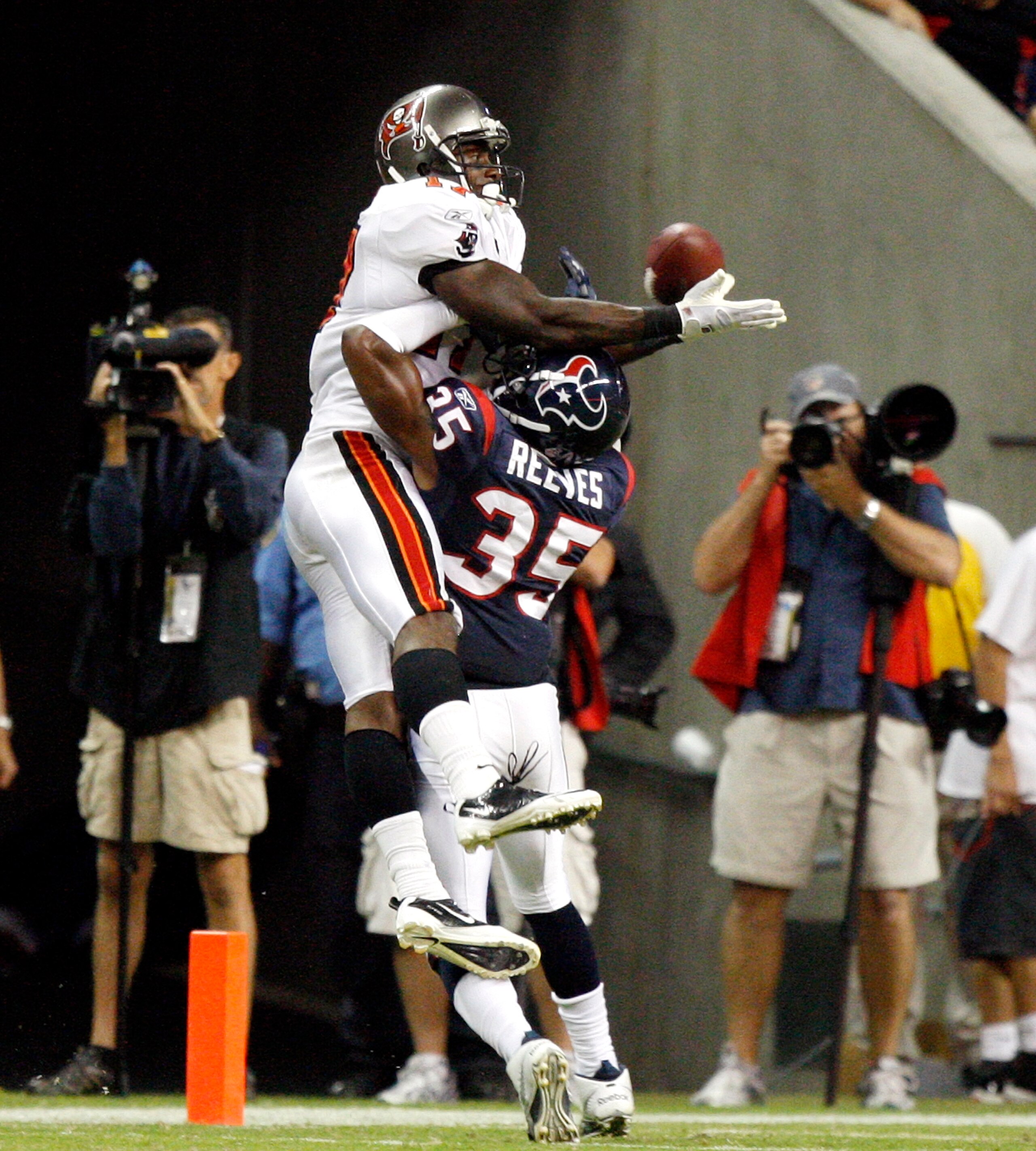 HOUSTON - SEPTEMBER 02:  Wide receiver Arrelious Benn #17 of the Tampa Bay Buccaneers leaps over cornerback Jacques Reeves #35 of the Houston Texans for a touchdown in the fourth quarter at Reliant Stadium on September 2, 2010 in Houston, Texas.  (Photo b