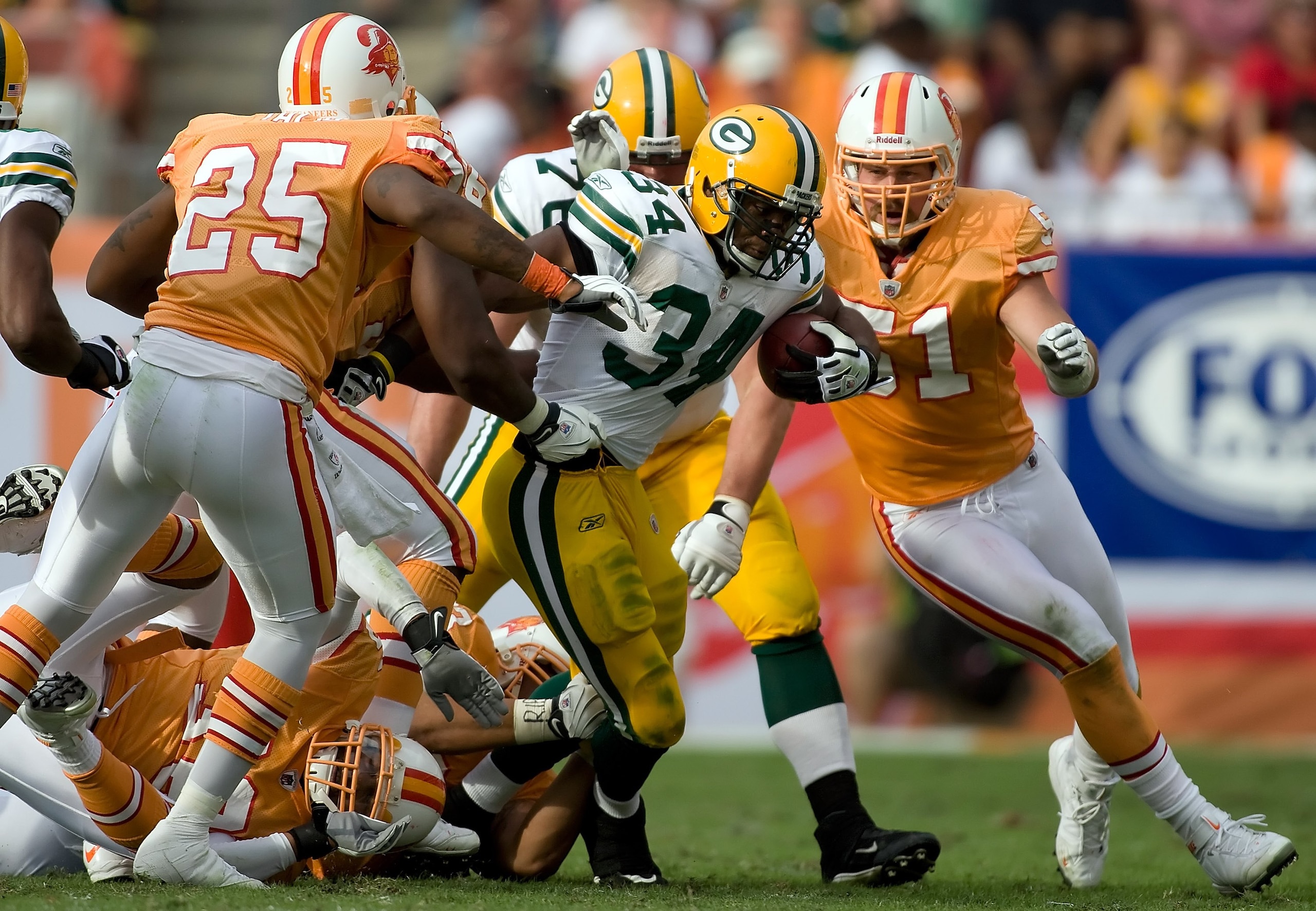 TAMPA, FL - NOVEMBER 08:  Running back Ahman Green #34 of the Green Bay Packers is tackled by linebacker Barrett Ruud #51 of the Tampa Bay Buccaneers during the game at Raymond James Stadium on November 8, 2009 in Tampa, Florida. The Buccaneers defeated t