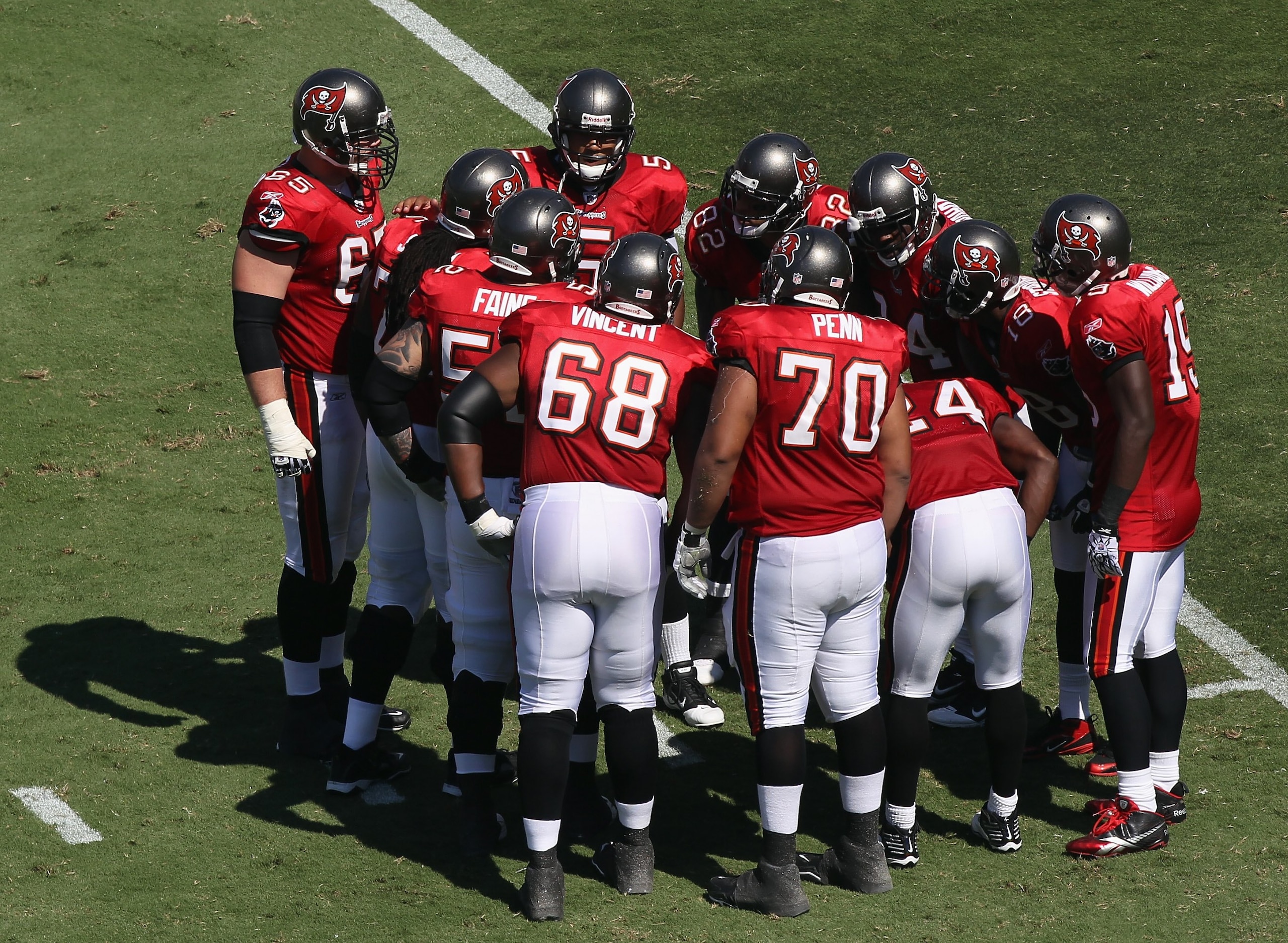 CHARLOTTE, NC - SEPTEMBER 19:  Josh Freeman #5 of the Tampa Bay Buccaneers stands in the huddle with teammates against the Carolina Panthers during their game at Bank of America Stadium on September 19, 2010 in Charlotte, North Carolina.  (Photo by Street