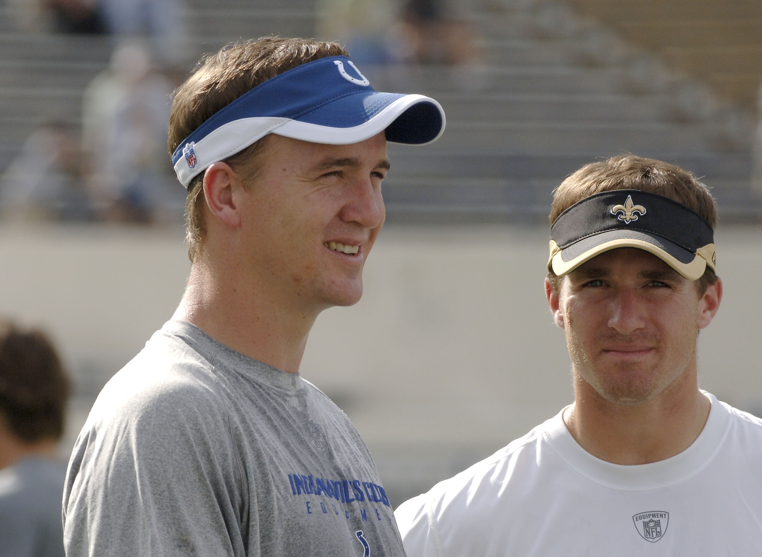 Indianapolis Colts quarterback Peyton Manning talks with New Orleans Saints quarterback Drew Brees at Veterans Memorial Stadium in Jackson, Mississippi on August 26, 2006. The Colts won 27-14. (Photo by A. Messerschmidt/Getty Images)