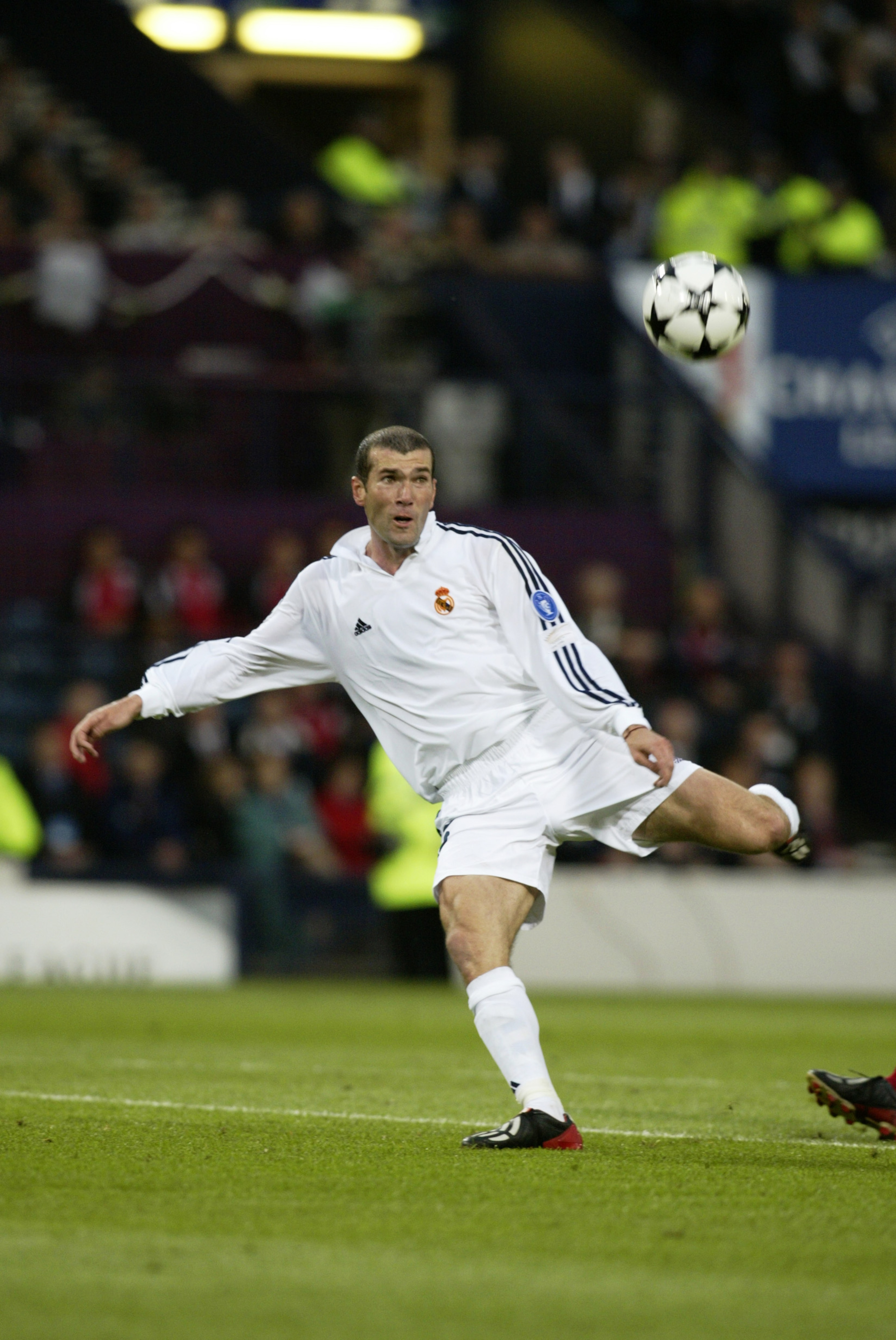 GLASGOW - May 15: Zinedine Zidane of Real Madrid keeps his eye on the ball as he scores a wonderful goal during the UEFA Champions League Final between Real Madrid and Bayer Leverkusen played at Hampden Park, in Glasgow, Scotland on May 15, 2002. Real Ma GLASGOW - May 15: Zinedine Zidane of Real Madrid keeps his eye on the ball as he scores a wonderful goal during the UEFA Champions League Final between Real Madrid and Bayer Leverkusen played at Hampden Park, in Glasgow, Scotland on May 15, 2002. Real Ma