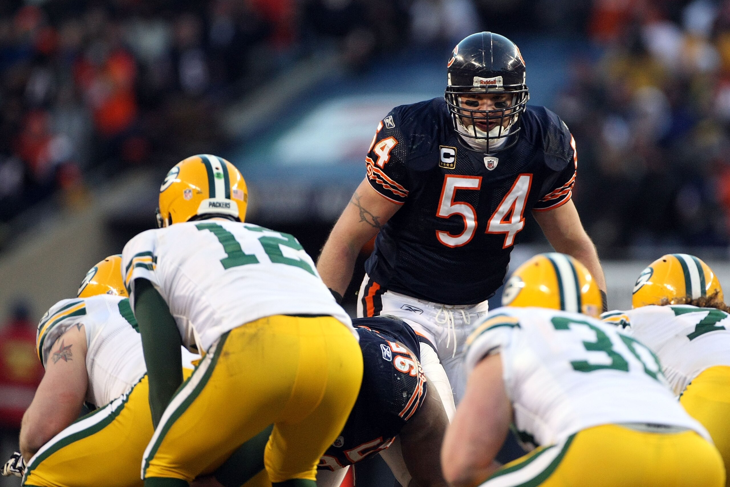 CHICAGO, IL - JANUARY 23:  Brian Urlacher #54 of the Chicago Bears looks over at Aaron Rodgers #12 of the Green Bay Packers before the snap in the NFC Championship Game at Soldier Field on January 23, 2011 in Chicago, Illinois.  (Photo by Doug Pensinger/G