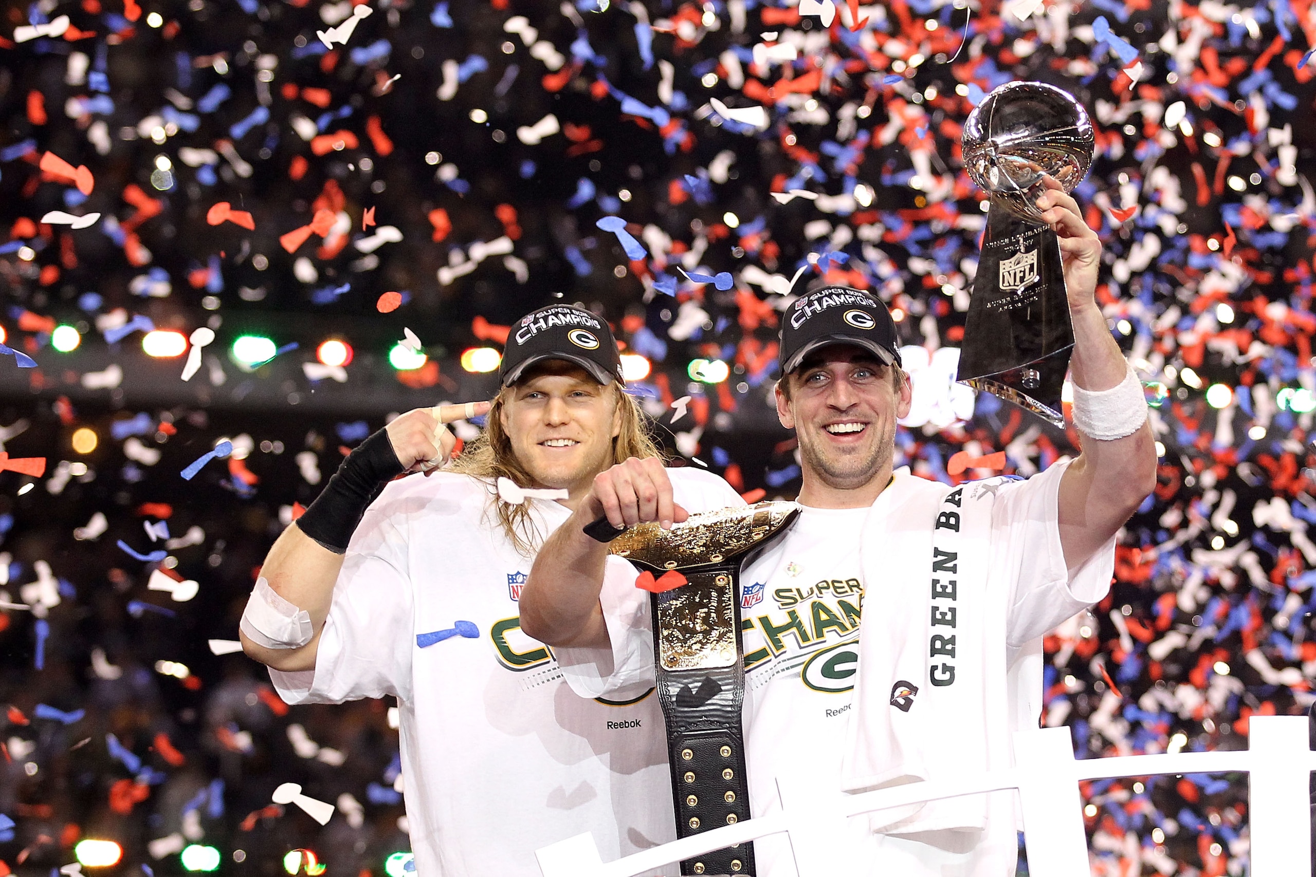 ARLINGTON, TX - FEBRUARY 06:  Super Bowl MVP Aaron Rodgers #12 (R) and Clay Matthews #52 of the Green Bay Packers celebrate with the Lombardi Trophy after winning Super Bowl XLV 31-25 against the Pittsburgh Steelers at Cowboys Stadium on February 6, 2011
