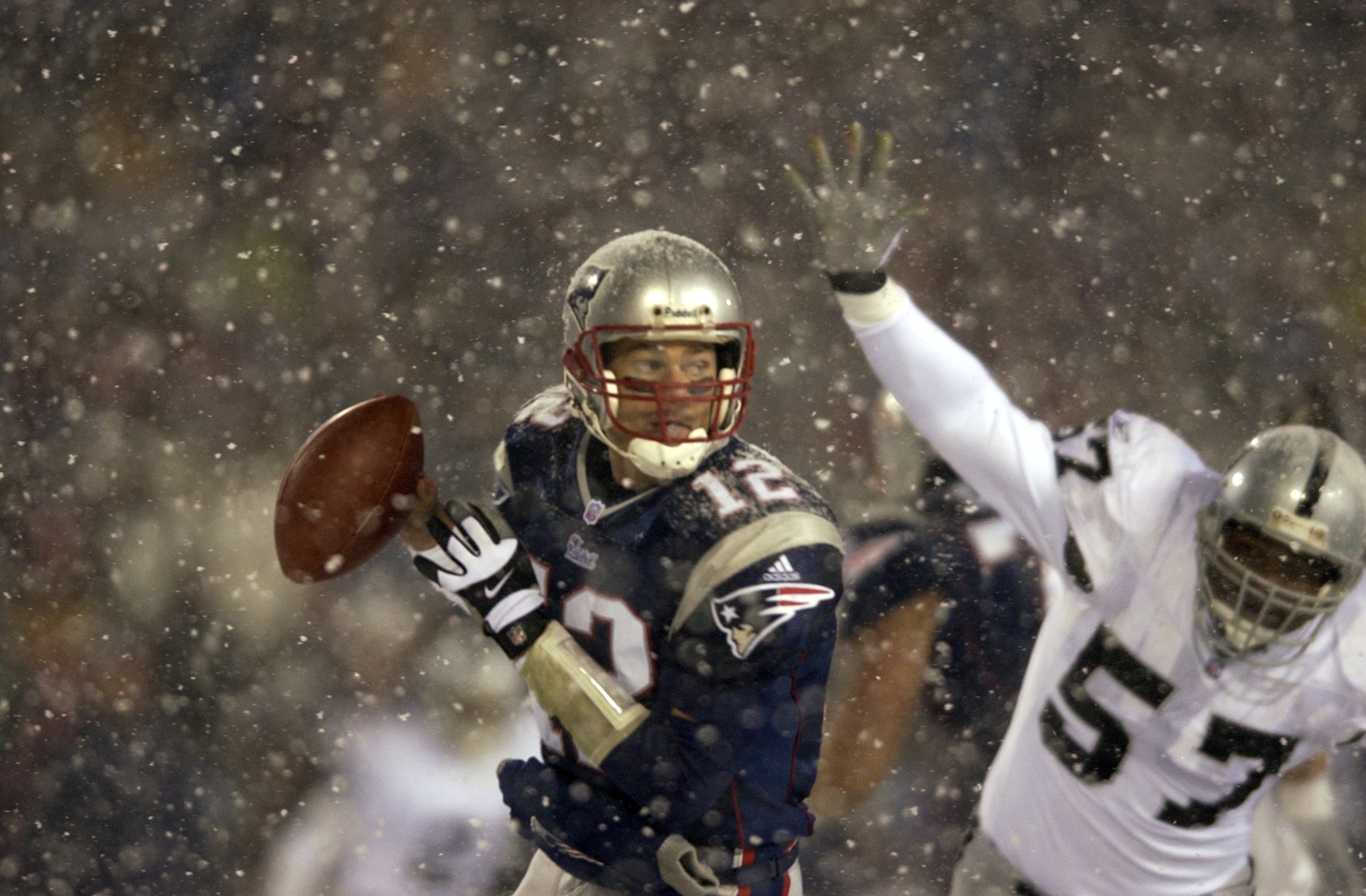 19 Jan 2002: Quarterback Tom Brady #12 of the New England Patriots scrambles against the defense of Rod Coleman #57 of the Oakland Raiders during the AFC playoff game at Foxboro Stadium in Foxboro, Massachuesetts. The Patriots came from behind to win 16- 19 Jan 2002: Quarterback Tom Brady #12 of the New England Patriots scrambles against the defense of Rod Coleman #57 of the Oakland Raiders during the AFC playoff game at Foxboro Stadium in Foxboro, Massachuesetts. The Patriots came from behind to win 16-