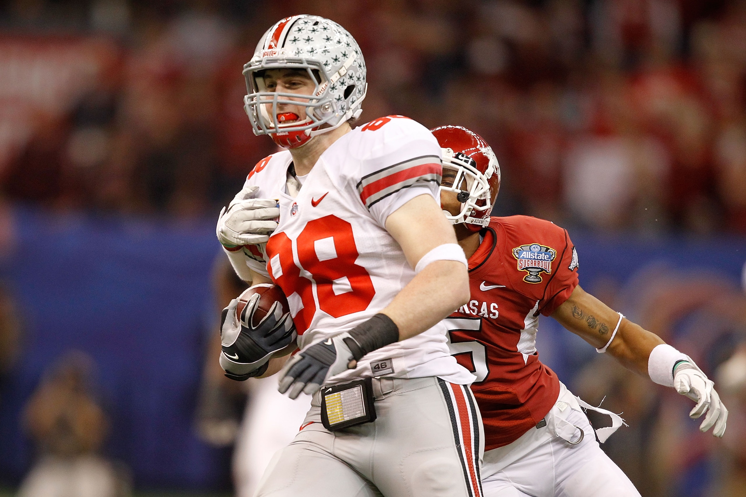 NEW ORLEANS, LA - JANUARY 04:  Reid Fragel #88 of the Ohio State Buckeyes runs after a catch for 42-yards in front of Tramain Thomas #5 of the Arkansas Razorbacks in the second quarter during the Allstate Sugar Bowl at the Louisiana Superdome on January 4