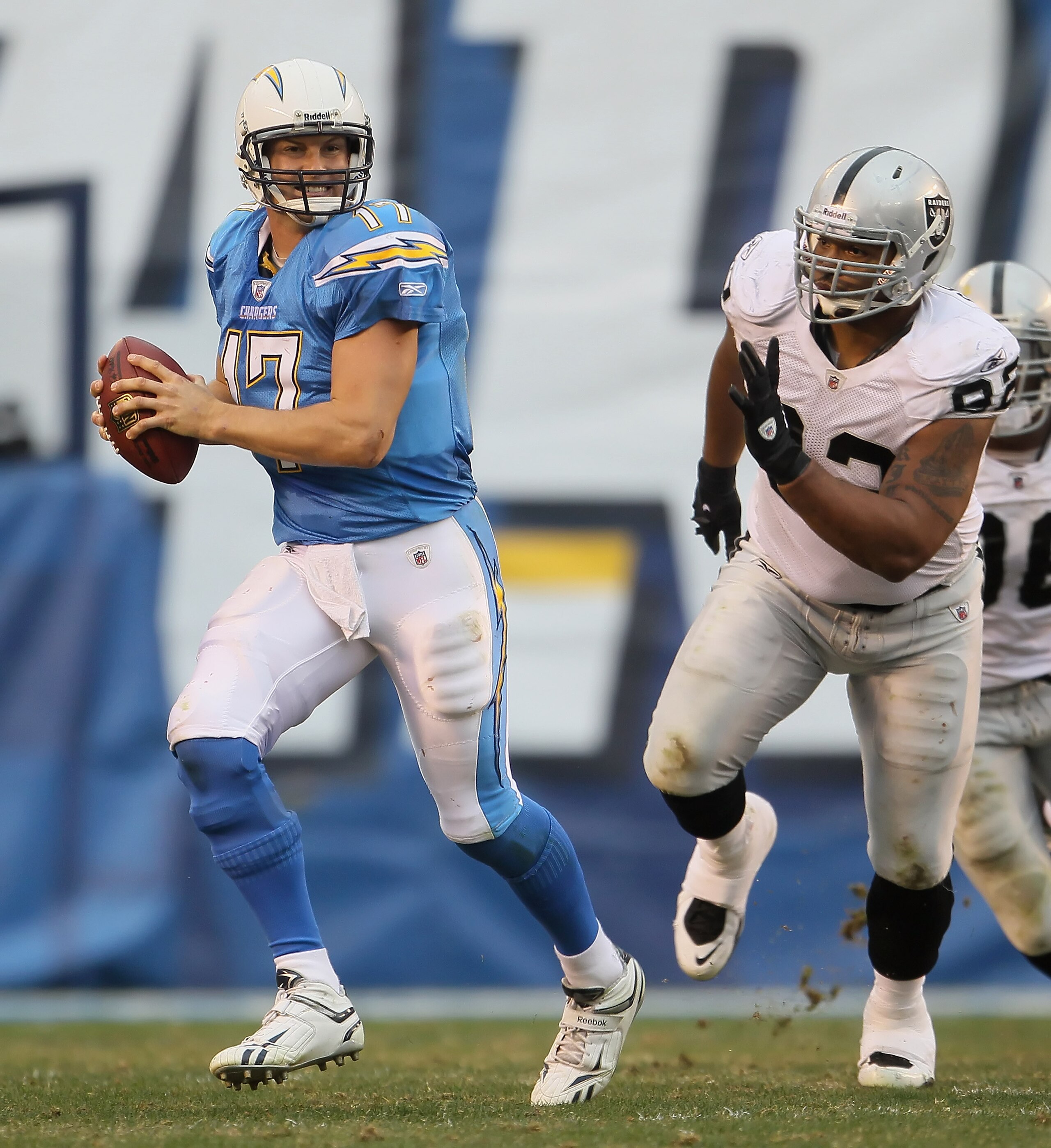 SAN DIEGO - DECEMBER 05: Quarterback Philip Rivers #17 of the San Diego Chargers is chased out of the pocket by Richard Seymour #92 of the Oakland Raiders in the third quarter at Qualcomm Stadium on December 5, 2010 in San Diego, California. The Raiders SAN DIEGO - DECEMBER 05: Quarterback Philip Rivers #17 of the San Diego Chargers is chased out of the pocket by Richard Seymour #92 of the Oakland Raiders in the third quarter at Qualcomm Stadium on December 5, 2010 in San Diego, California. The Raiders