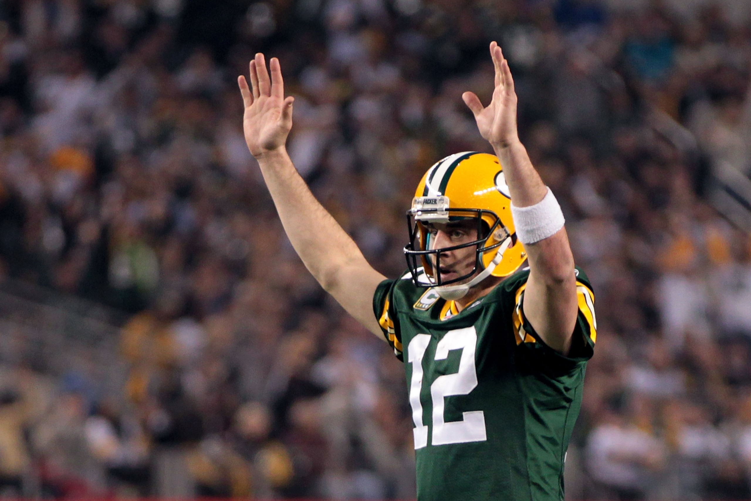 ARLINGTON, TX - FEBRUARY 06:  Aaron Rodgers #12 of the Green Bay Packers celebrates after an 8 yard touchdown pass to Greg Jennings against the Pittsburgh Steelers during Super Bowl XLV at Cowboys Stadium on February 6, 2011 in Arlington, Texas.  (Photo b