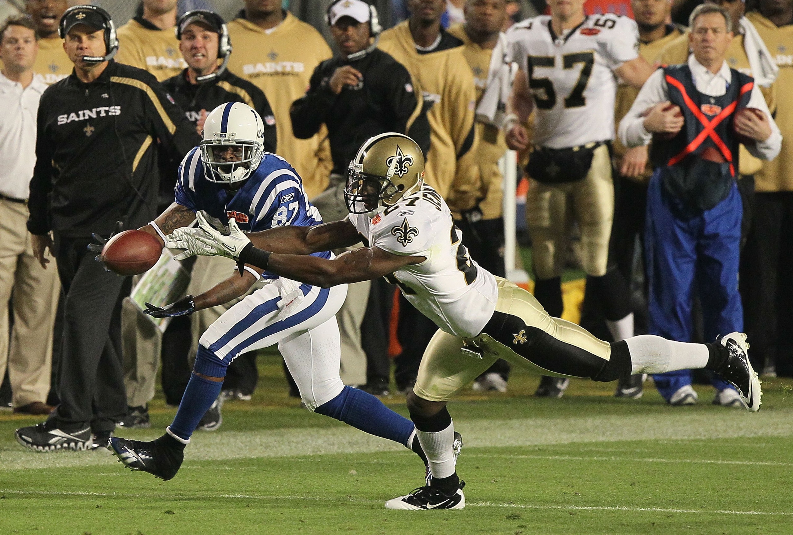 MIAMI GARDENS, FL - FEBRUARY 07:  Malcolm Jenkins #27 of the New Orleans Saints breaks up a pass to Reggie Wayne #87 of the Indianapolis Colts during Super Bowl XLIV on February 7, 2010 at Sun Life Stadium in Miami Gardens, Florida.  (Photo by Jed Jacobso