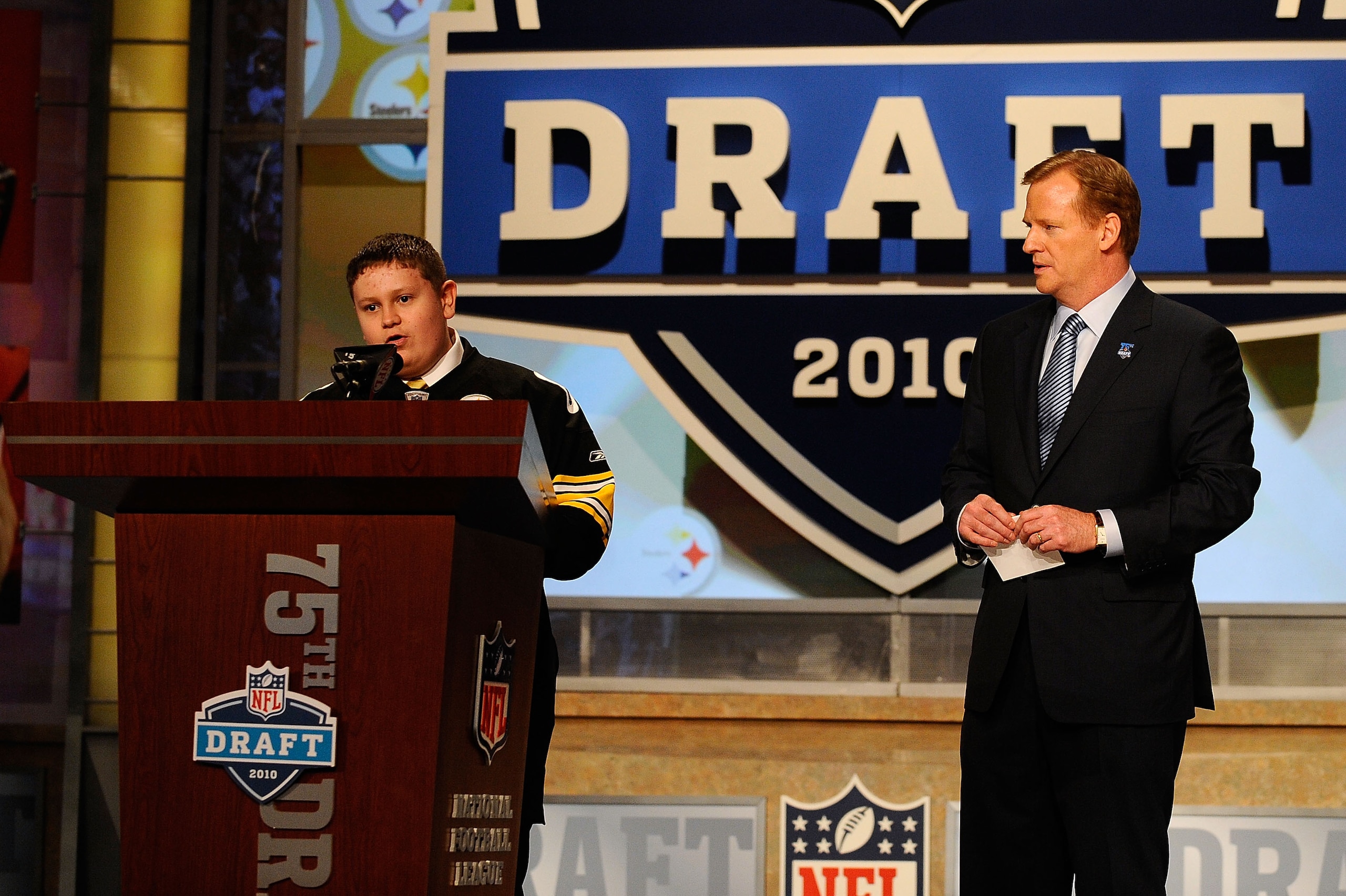 NEW YORK - APRIL 22:  NFL Commissioner Roger Goodell looks watches as 16-year old Zachary Hatfield (L) from Florence, KY announces that Maurkice Pouncey from the Florida Gators was selected by the Pittsburgh Steelers number 18 overall during the first rou