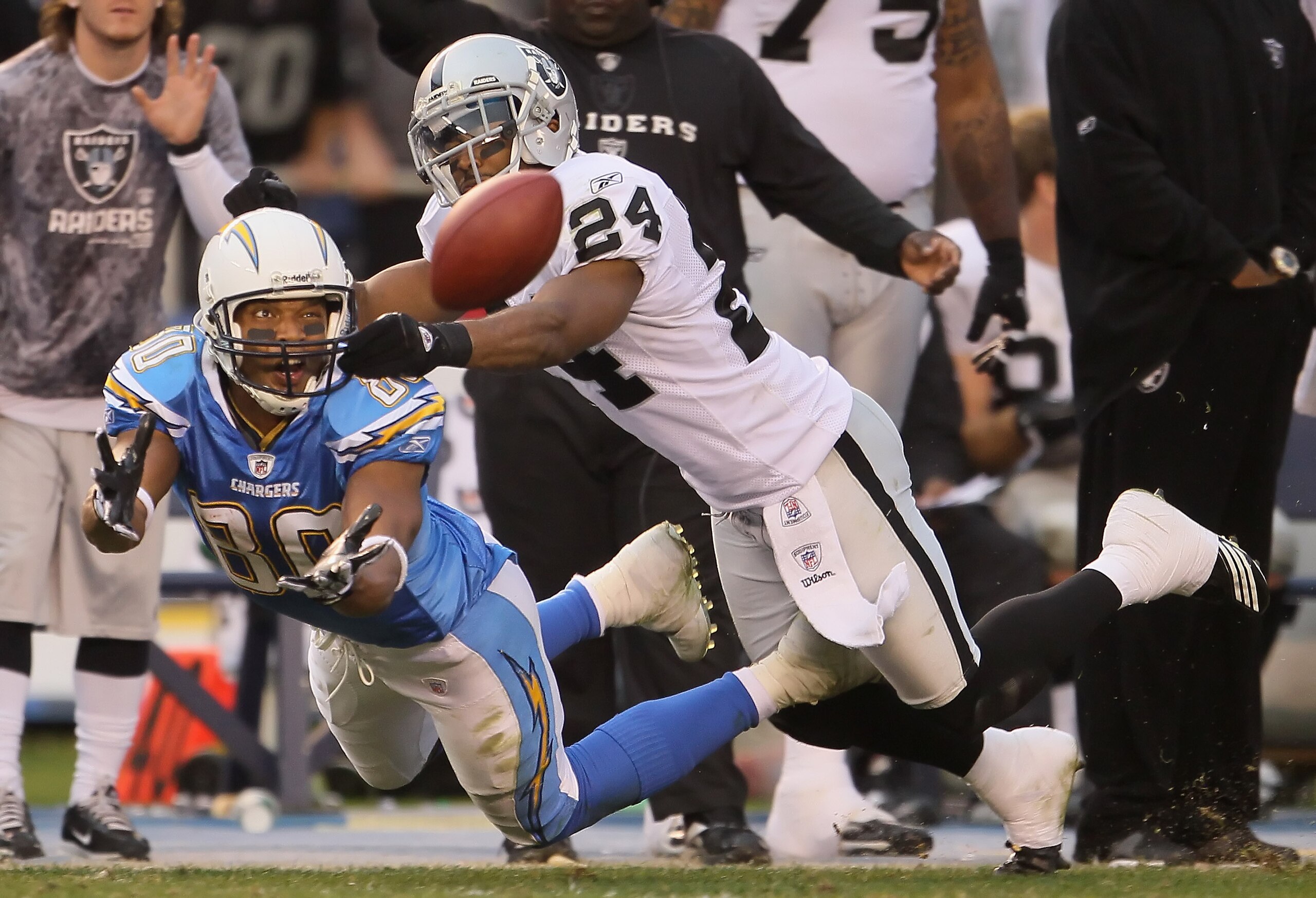 SAN DIEGO - DECEMBER 05:  Michael Huff #24 of the Oakland Raiders breaks up a pass intended for wide receiver Malcolm Floyd #80 of the San Diego Chargers at Qualcomm Stadium on December 5, 2010 in San Diego, California. The Raiders defeated the Chargers 2