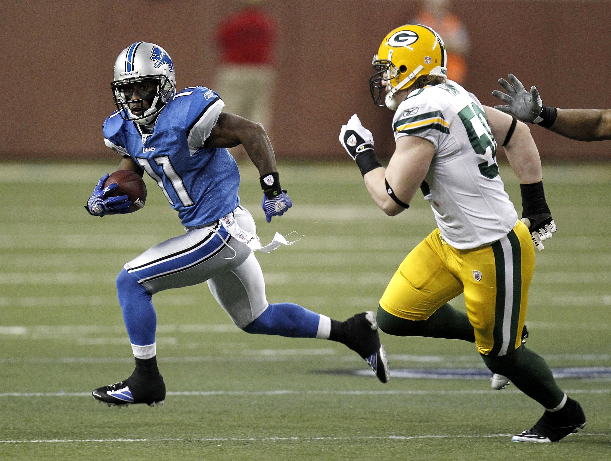 DETROIT, MI - DECEMBER 12:  Stefan Logan #11 of the Detroit Lions tries to get around A.J. Hawk #50 of the Green Bay Packers on December 12, 2010 at Ford Field in Detroit, Michigan. Detroit won the game 7-3  (Photo by Gregory Shamus/Getty Images)