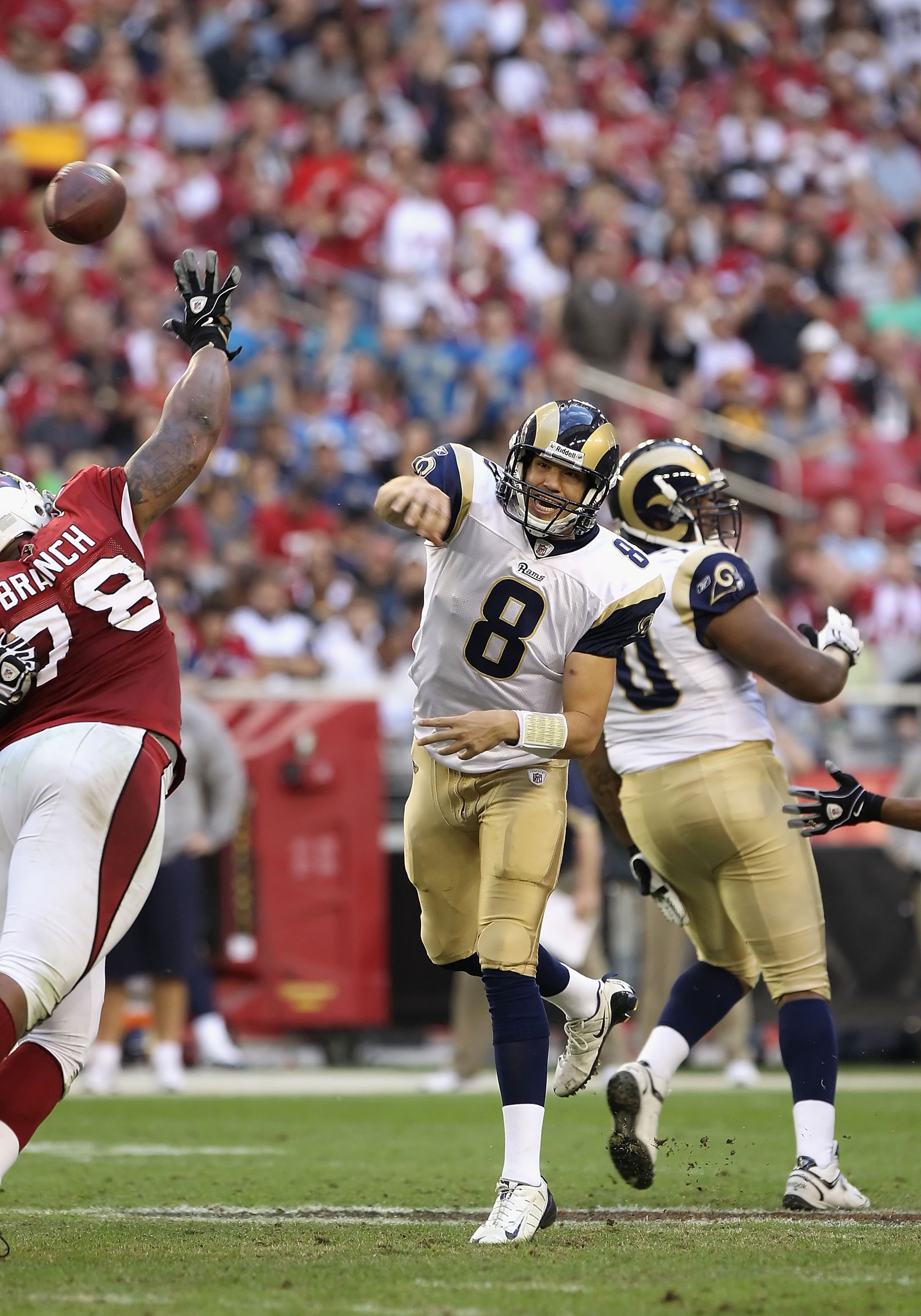 GLENDALE, AZ - DECEMBER 05:  Quarterback Sam Bradford #8 of the St. Louis Rams throws the football during the NFL game against the Arizona Cardinals at the University of Phoenix Stadium on December 5, 2010 in Glendale, Arizona. The Rams defeated the Cardi