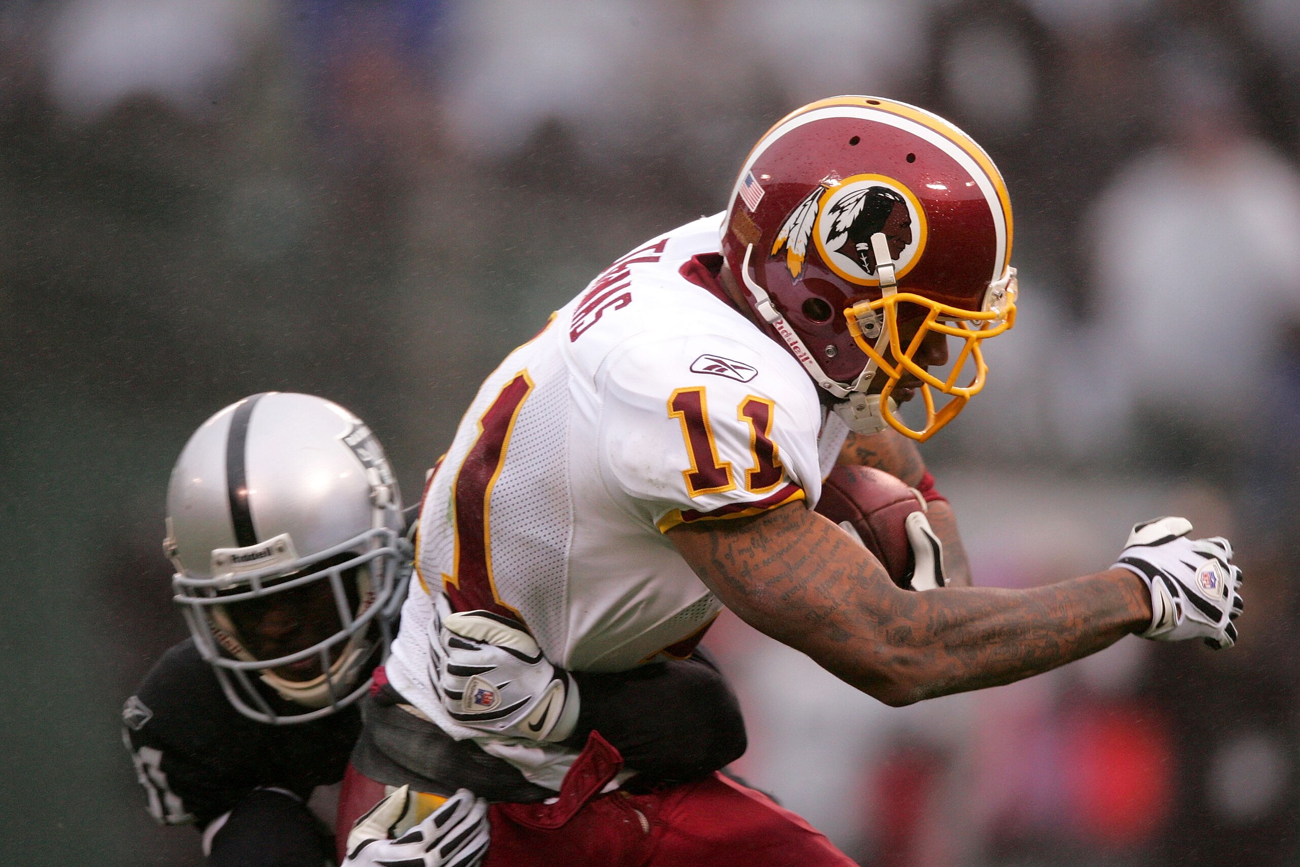 OAKLAND, CA - DECEMBER 13: Devin Thomas #11 of the Washington Redskins is tackled by Hiram Eugene #31 of the Oakland Raiders at Oakland-Alameda County Coliseum on December 13, 2009 in Oakland, California. (Photo by Ezra Shaw/Getty Images) OAKLAND, CA - DECEMBER 13: Devin Thomas #11 of the Washington Redskins is tackled by Hiram Eugene #31 of the Oakland Raiders at Oakland-Alameda County Coliseum on December 13, 2009 in Oakland, California. (Photo by Ezra Shaw/Getty Images)