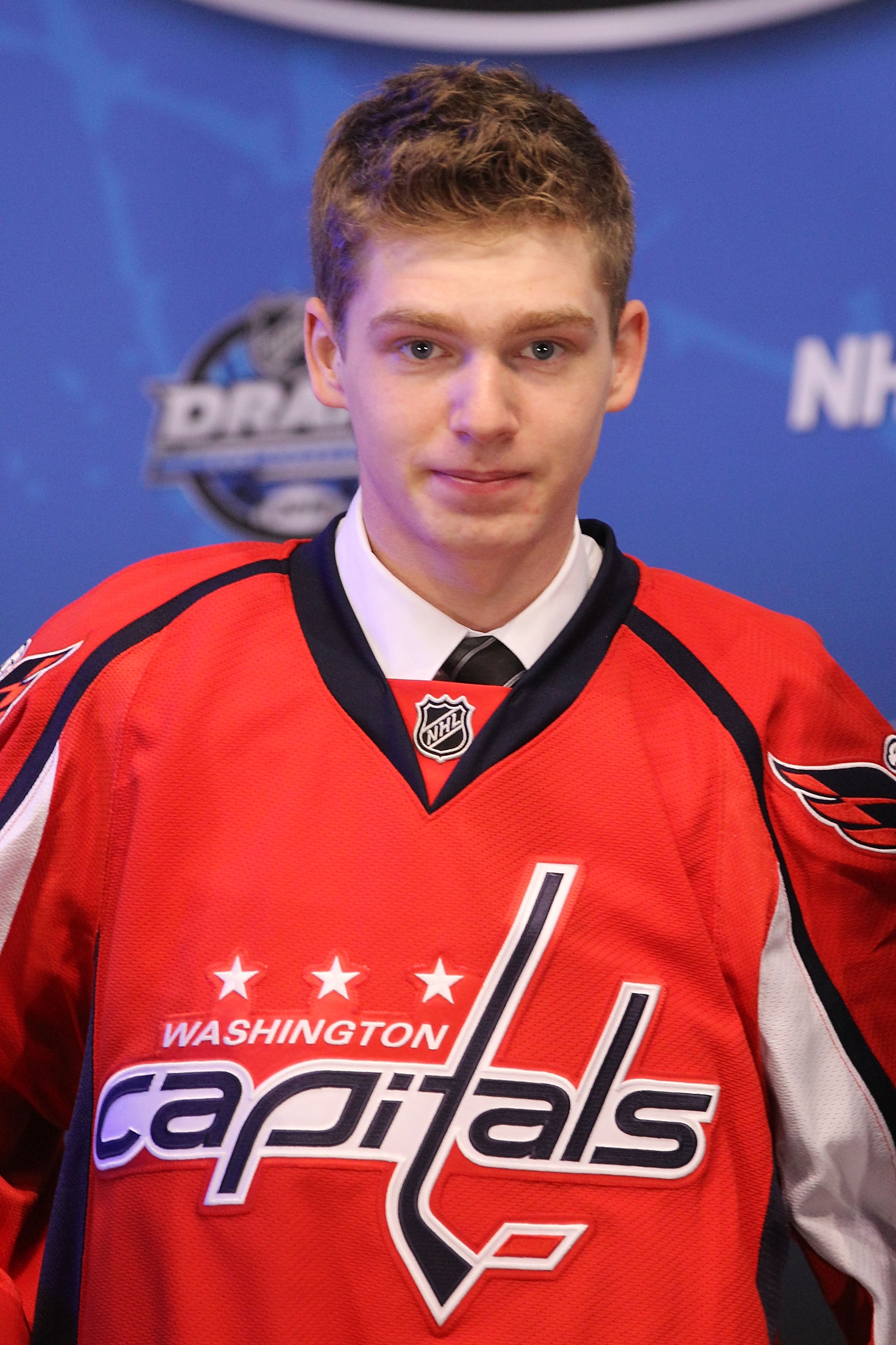 LOS ANGELES, CA - JUNE 25:  Evgeny Kuznetsov, drafted 26th overall by the Washington Capitals, poses on stage during the 2010 NHL Entry Draft at Staples Center on June 25, 2010 in Los Angeles, California.  (Photo by Bruce Bennett/Getty Images)