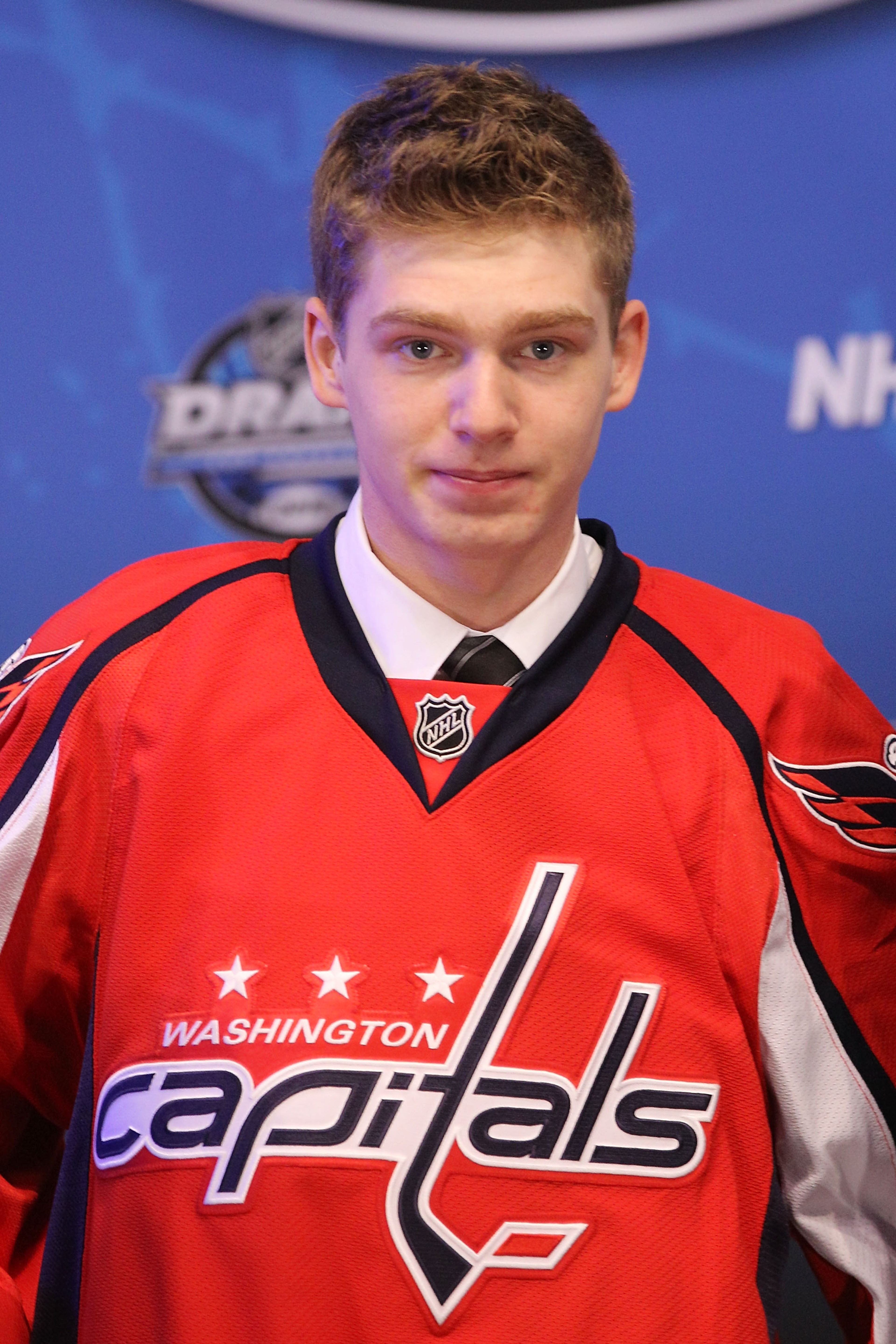 LOS ANGELES, CA - JUNE 25:  Evgeny Kuznetsov, drafted 26th overall by the Washington Capitals, poses on stage during the 2010 NHL Entry Draft at Staples Center on June 25, 2010 in Los Angeles, California.  (Photo by Bruce Bennett/Getty Images)