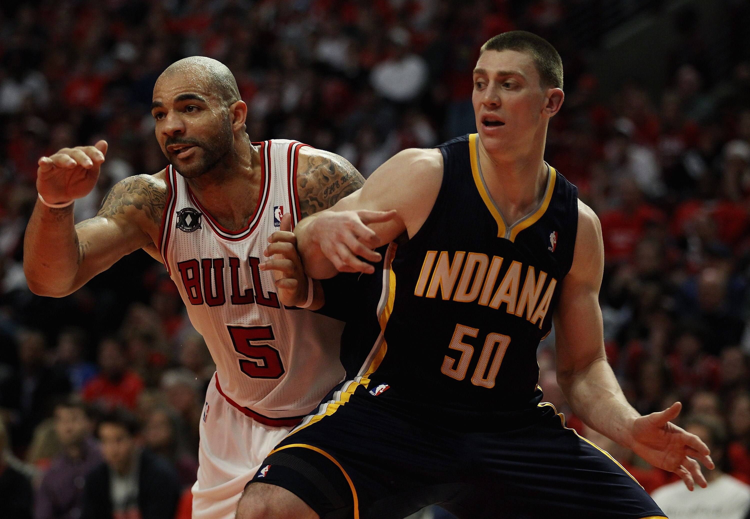 CHICAGO, IL - APRIL 16: Carlos Boozer #5 of the Chicago Bulls and Tyler Hansbrough #50 of the Indiana Pacers battle for position on a free-throw in Game One of the Eastern Conference Quarterfinals in the 2011 NBA Playoffs at the United Center on April 16,
