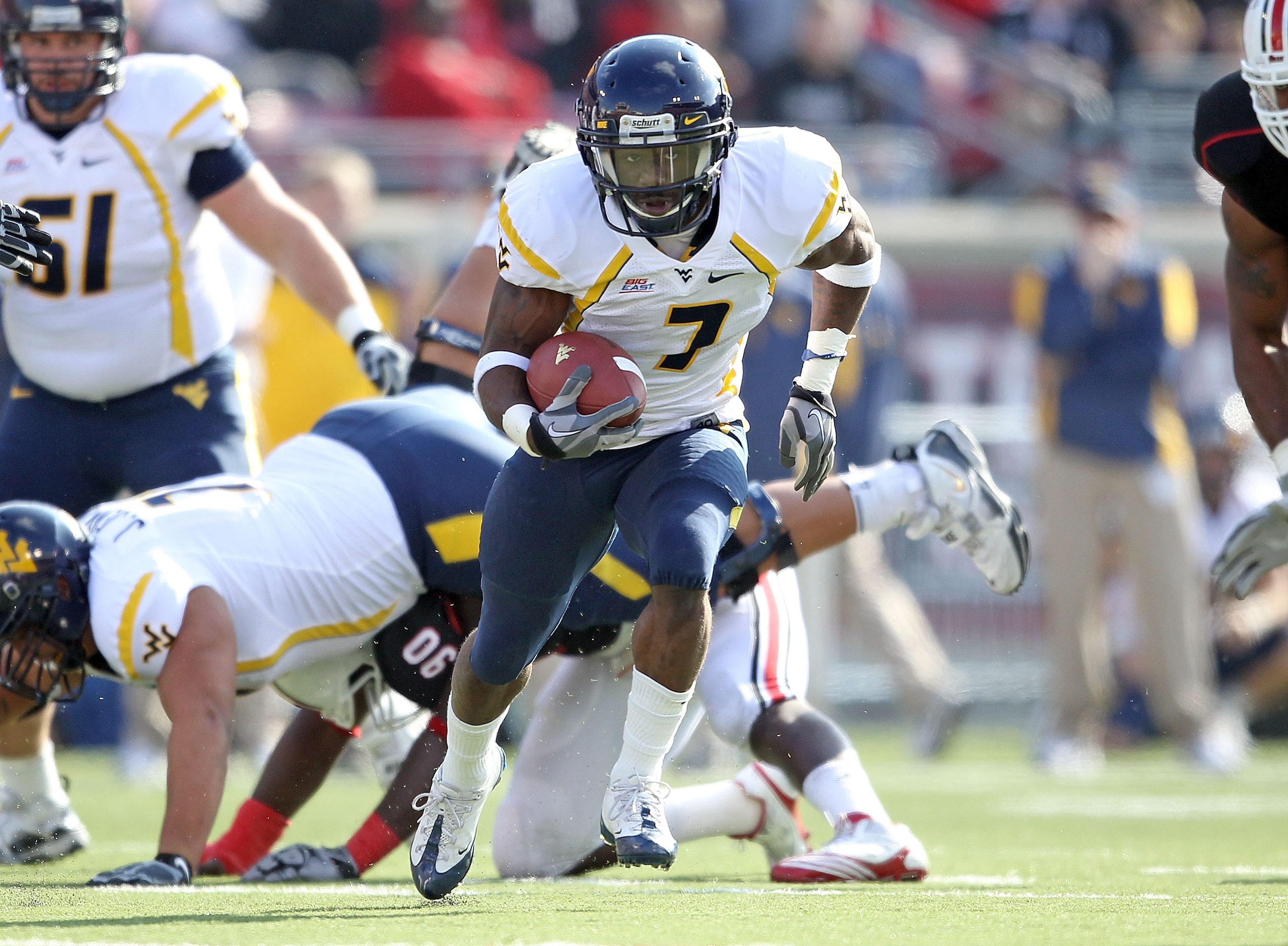 LOUISVILLE, KY - NOVEMBER 20: Noel Devine #7 of the West Virginia Mountaineers runs with the ball during the Big East Conference game against the Louisville Cardinals at Papa John's Cardinal Stadium on November 20, 2010 in Louisville, Kentucky. (Photo b LOUISVILLE, KY - NOVEMBER 20: Noel Devine #7 of the West Virginia Mountaineers runs with the ball during the Big East Conference game against the Louisville Cardinals at Papa John's Cardinal Stadium on November 20, 2010 in Louisville, Kentucky. (Photo b