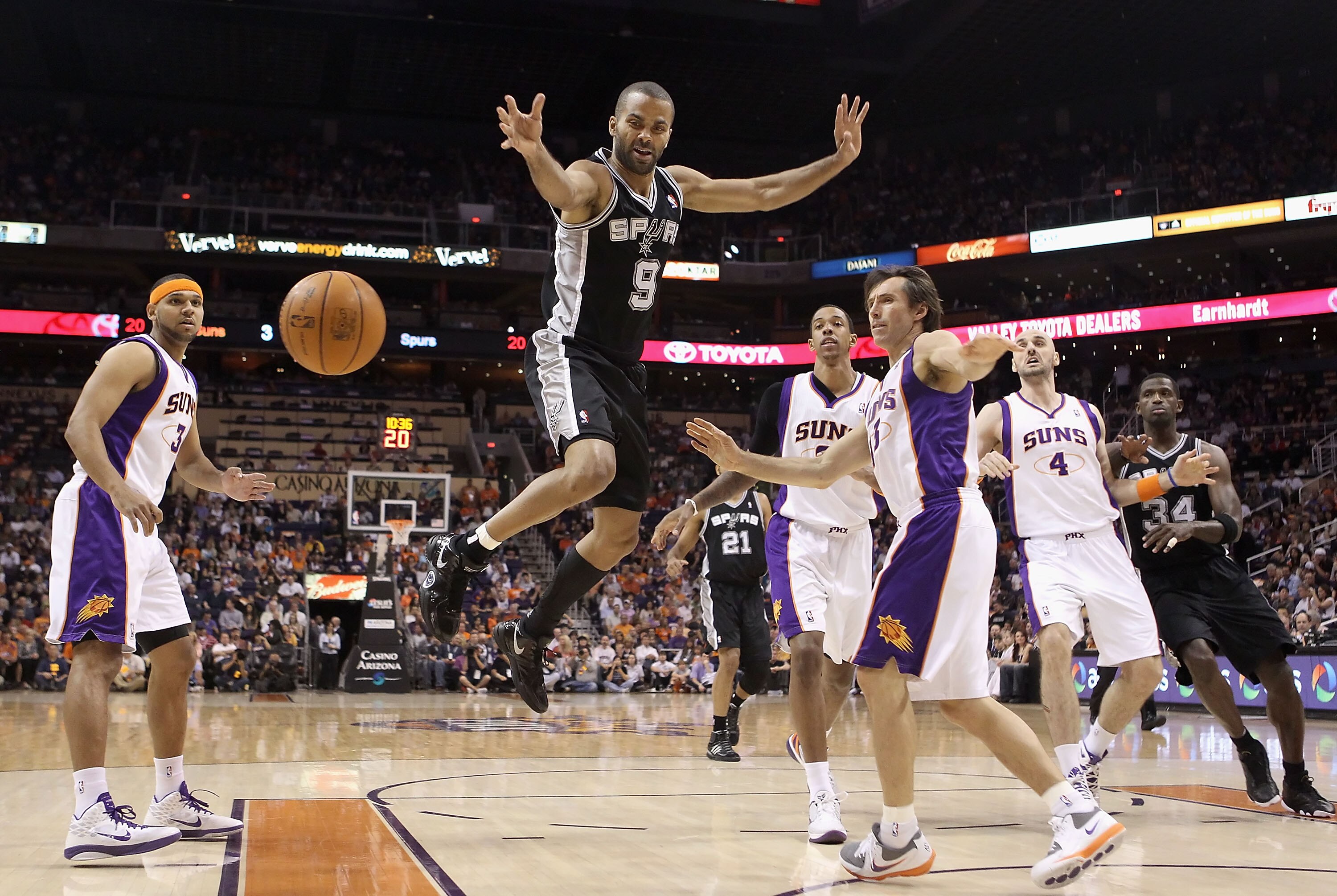 PHOENIX, AZ - APRIL 13:  Tony Parker #9 of the San Antonio Spurs looses the ball as he drives to the net past Steve Nash #13 of the Phoenix Suns during the NBA game at US Airways Center on April 13, 2011 in Phoenix, Arizona.  NOTE TO USER: User expressly