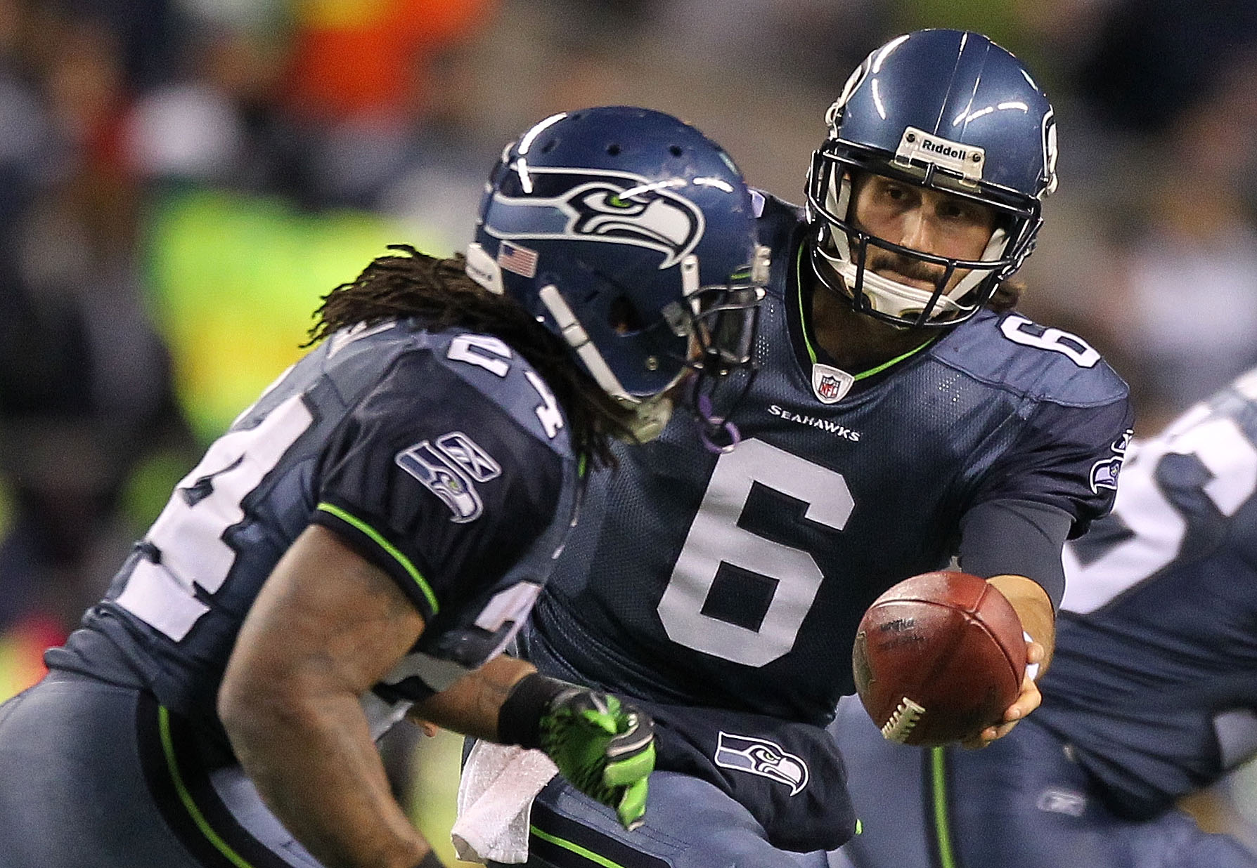 Seattle Seahawks' quarterback Charlie Whitehurst (L) watches a pass  completion to running back Justin Forsett against the St. Louis Rams in the  first quarter of the NFL's Western Division Championship game on