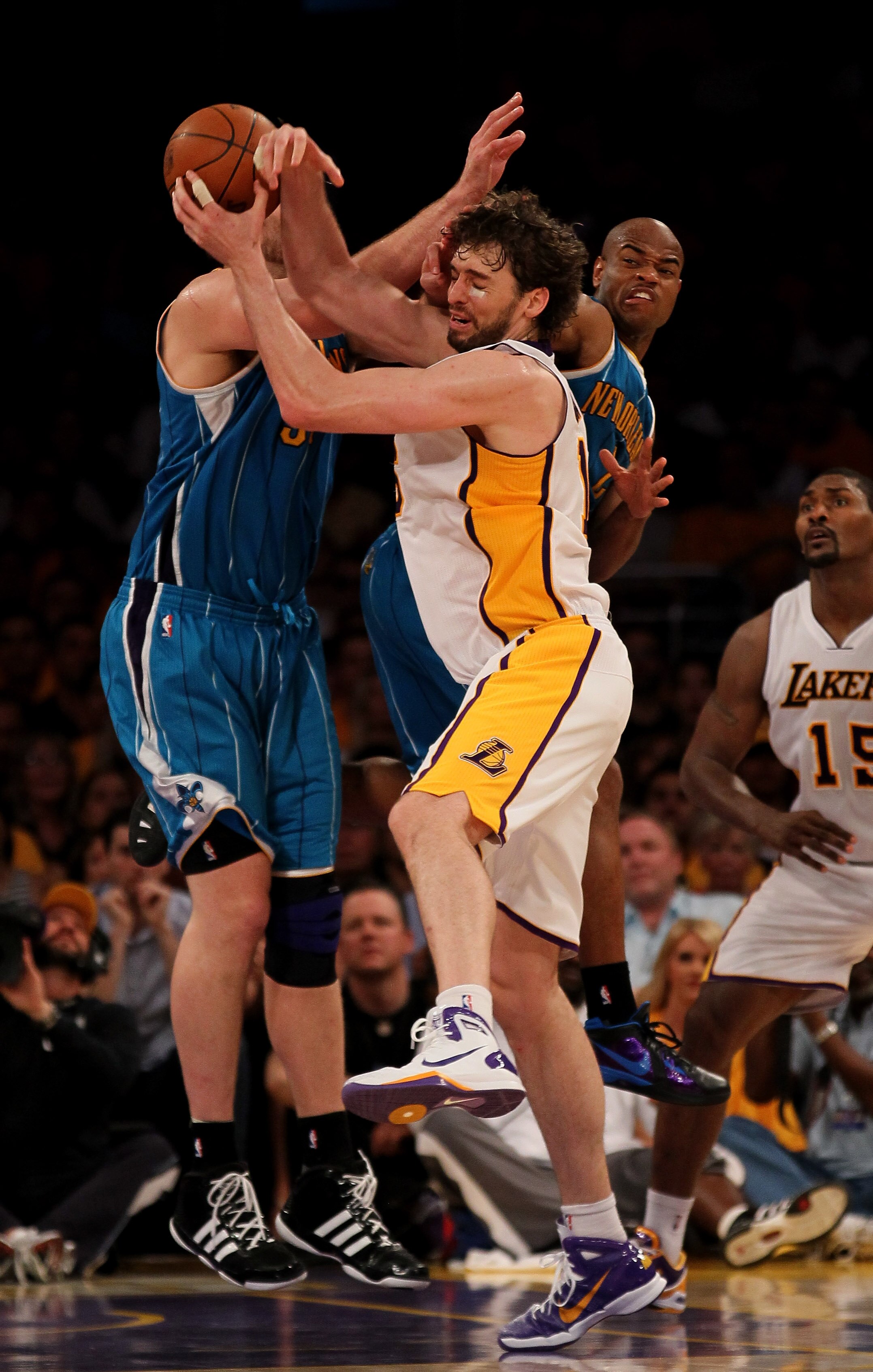 LOS ANGELES, CA - APRIL 17:  Pau Gasol #16 of the Los Angeles Lakers fights for the ball with Aaron Gray #34 and Jarrett Jack #2 of  the New Orleans Hornets in Game One of the Western Conference Quarterfinals in the 2011 NBA Playoffs on April 17, 2011 at