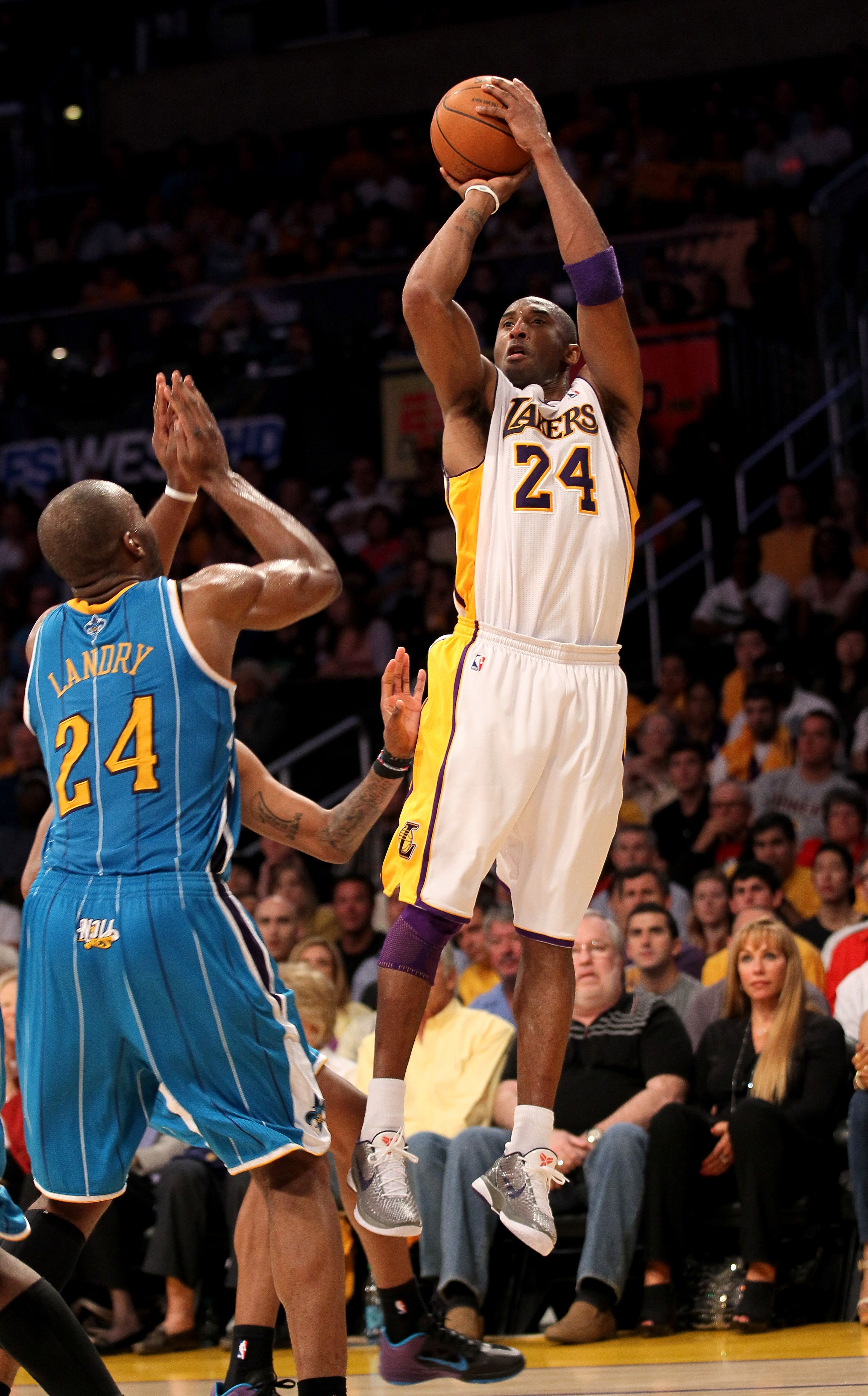 LOS ANGELES, CA - APRIL 17:  Kobe Bryant #24 of the Los Angeles Lakers shoots over Carl Landry #24 of the New Orleans Hornets in Game One of the Western Conference Quarterfinals in the 2011 NBA Playoffs on April 17, 2011 at Staples Center in Los Angeles,