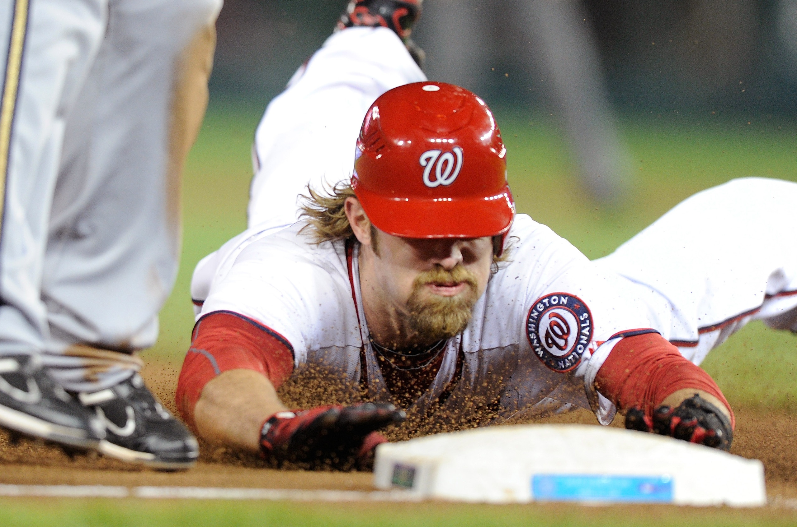 WASHINGTON, DC - APRIL 15:  Jayson Werth #28 of the Washington Nationals steals third base in the tenth inning against the Milwaukee Brewers at Nationals Park on April 15, 2011 in Washington, DC. All players, coaches and umpires are wearing #42 in honor o