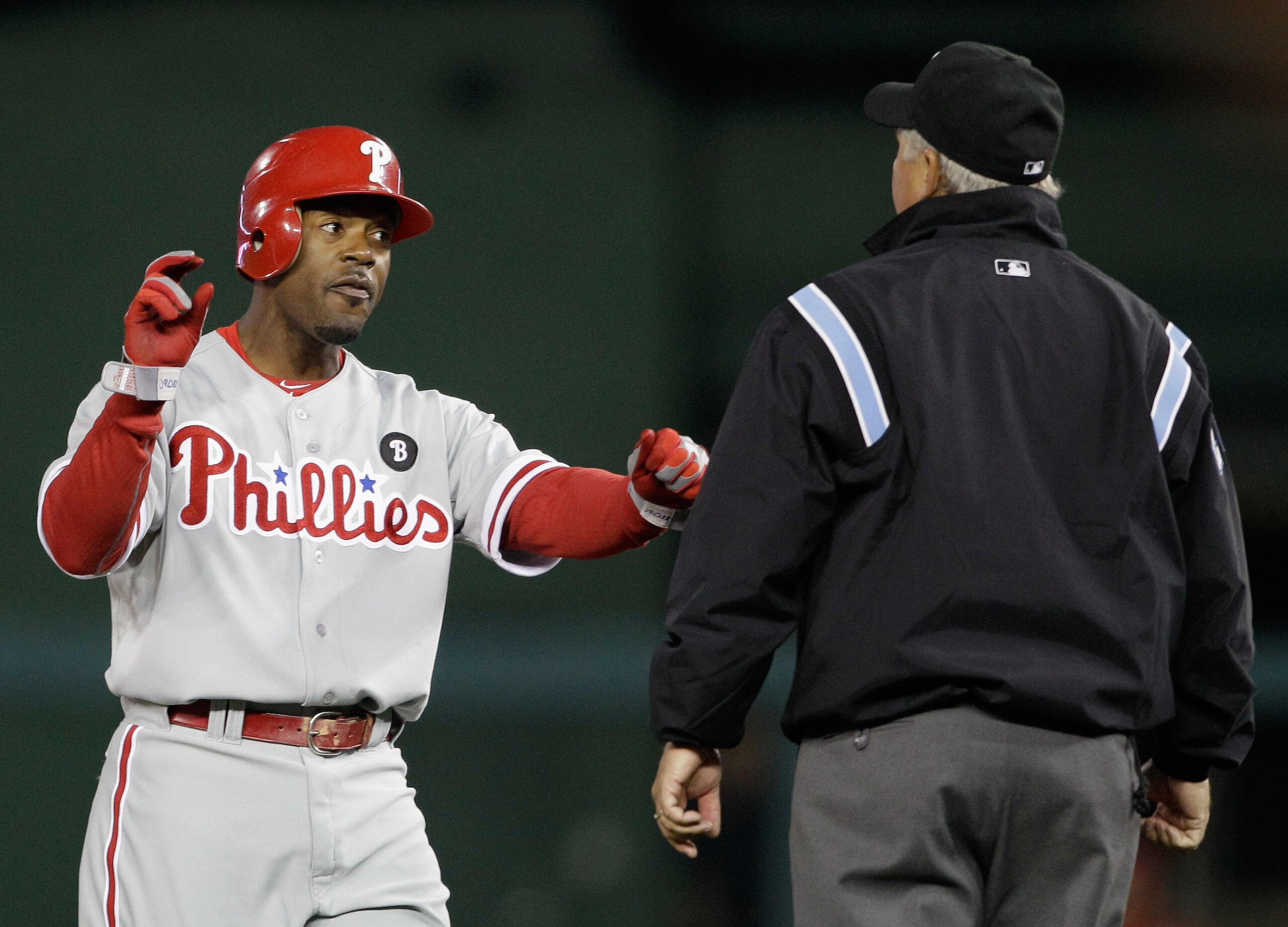 WASHINGTON, DC - APRIL 12:  Jimmy Rollins #11 of the Philadelphia Phillies disagrees with a call by umpire Tom Hallion during the fourth inning against the Washington Nationals at Nationals Park on April 12, 2011 in Washington, DC.  (Photo by Rob Carr/Get