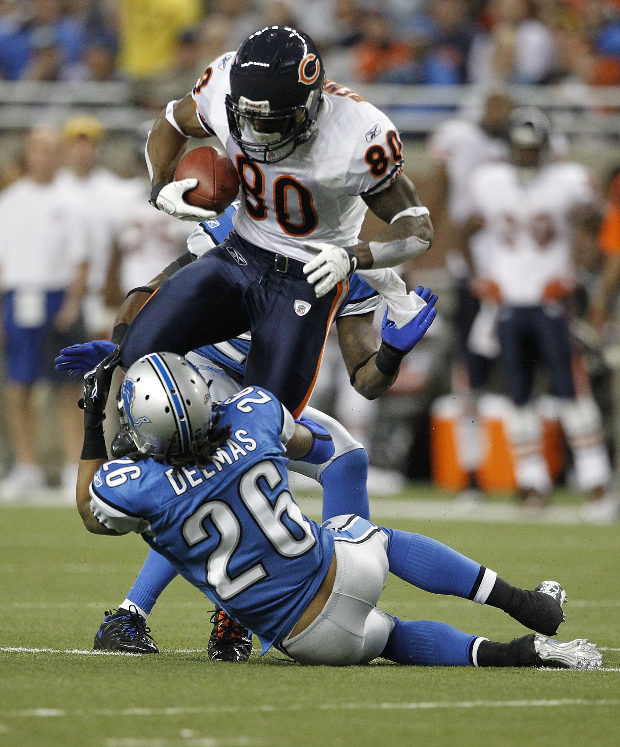 DETROIT - DECEMBER 05: Earl Bennett #80 of the Chicago Bears catches a 12 yard pass for a first down as Louis Delmas #26 of the Detroit Lions makes the stop during the game at Ford Field on December 5, 2010 in Detroit, Michigan. The Bears defeated the Lio