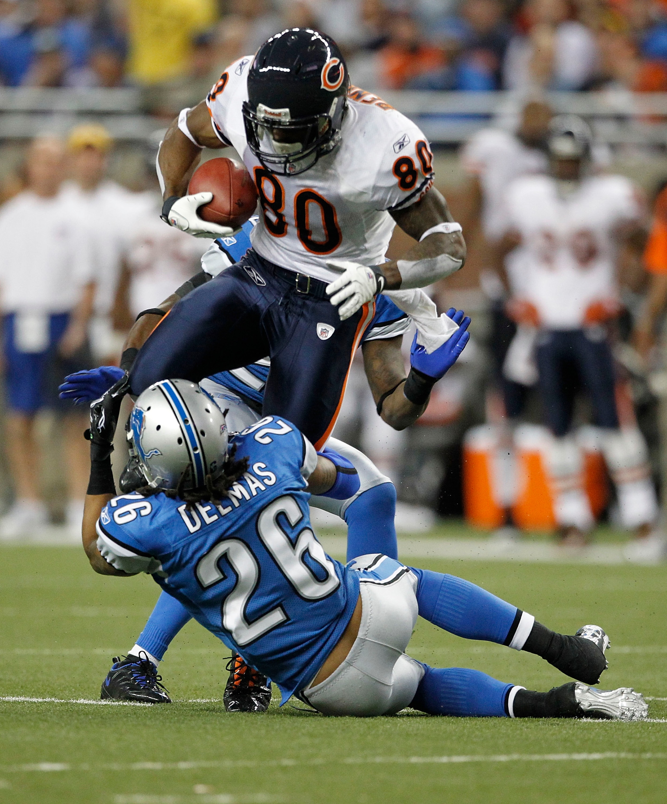 DETROIT - DECEMBER 05: Earl Bennett #80 of the Chicago Bears catches a 12 yard pass for a first down as Louis Delmas #26 of the Detroit Lions makes the stop during the game at Ford Field on December 5, 2010 in Detroit, Michigan. The Bears defeated the Lio