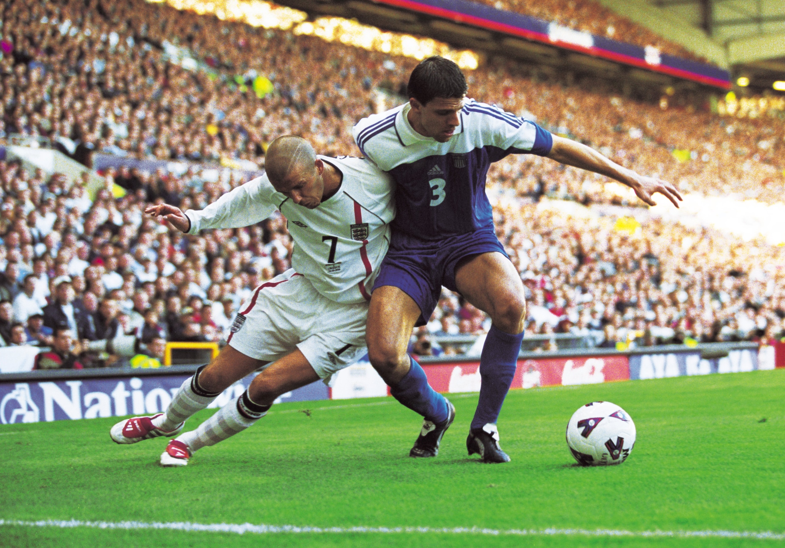 6 Oct 2001:  David Beckham of England battles with Panos Fissas of Greece during the World Cup Group 9 Qualifier between England and Greece at Old Trafford in Manchester, England. England sealed qualification after the game ended 2-2.   \ Mandatory Credit
