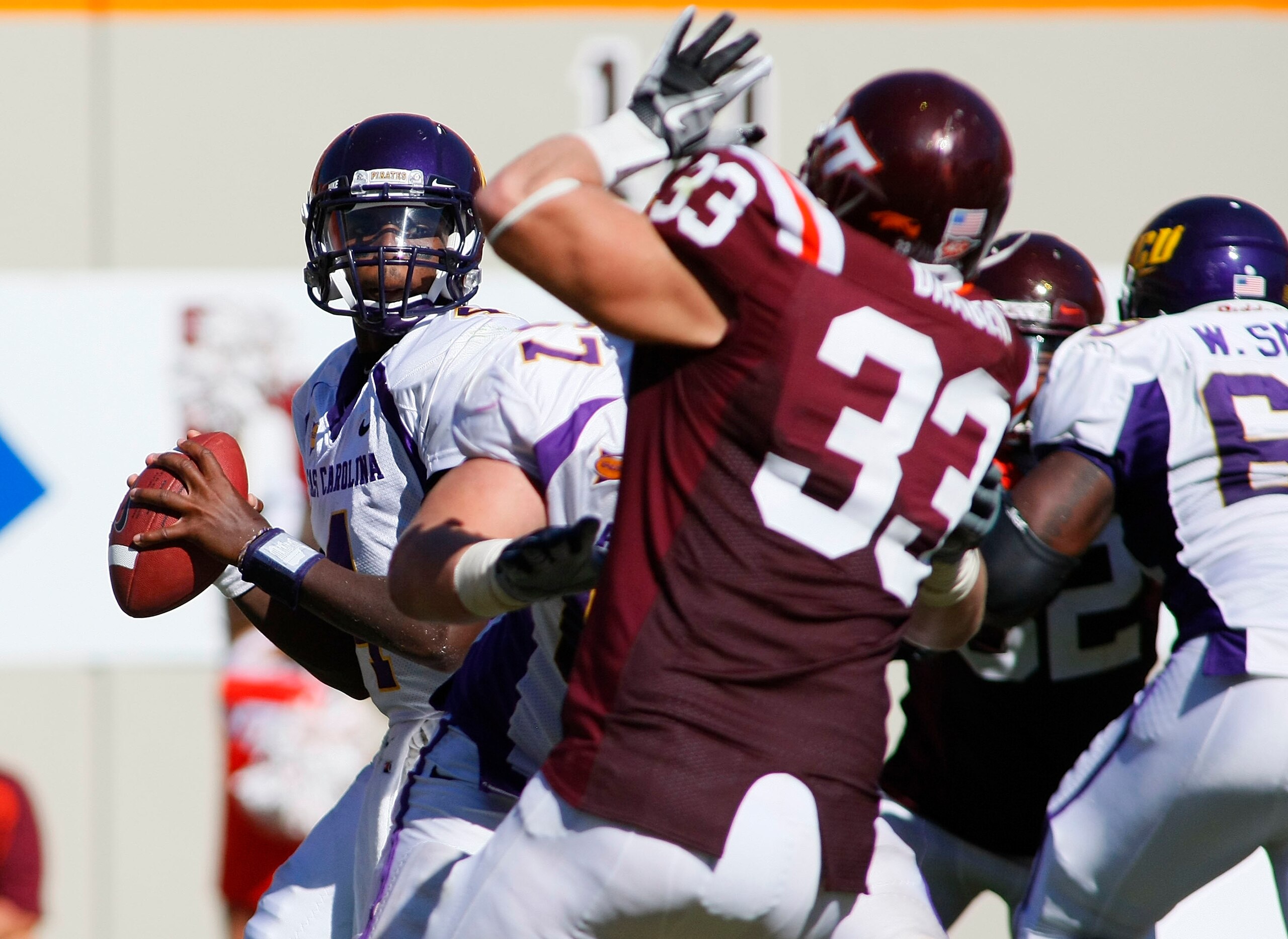 BLACKSBURG, VA - SEPTEMBER 18: Quarterback Dominique Davis #4 of the East Carolina Pirates prepares to pass the ball as defensive end Chris Drager #33 of the Virginia Tech Hokies defends at Lane Stadium on September 18, 2010 in Blacksburg, Virginia. (Pho BLACKSBURG, VA - SEPTEMBER 18: Quarterback Dominique Davis #4 of the East Carolina Pirates prepares to pass the ball as defensive end Chris Drager #33 of the Virginia Tech Hokies defends at Lane Stadium on September 18, 2010 in Blacksburg, Virginia. (Pho