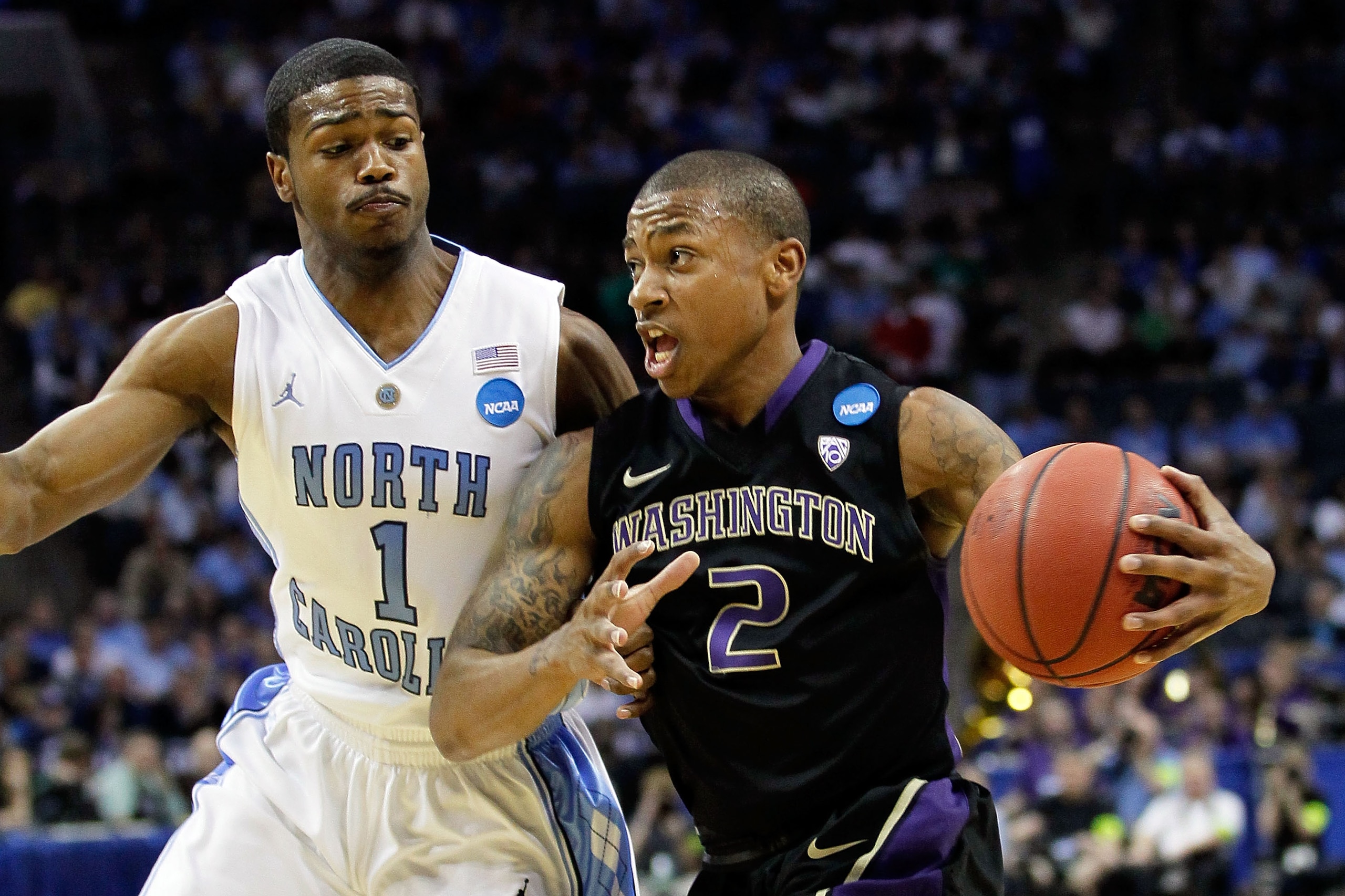 CHARLOTTE, NC - MARCH 20:  Isaiah Thomas #2 of the Washington Huskies drives on Dexter Strickland #1 of the North Carolina Tar Heels during the third round of the 2011 NCAA men's basketball tournament at Time Warner Cable Arena on March 20, 2011 in Charlo