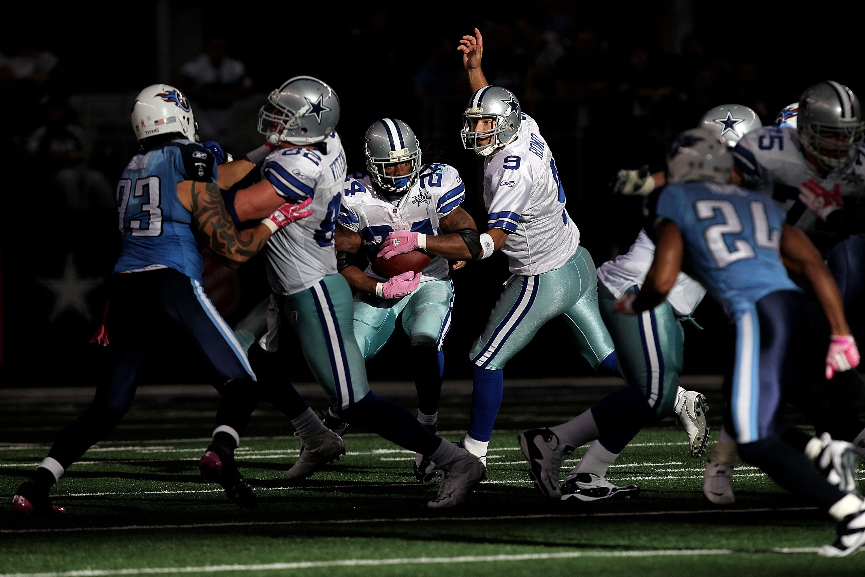 ARLINGTON, TX - OCTOBER 10:  Quarterback Tony Romo #9 of the Dallas Cowboys hands the ball to Marion Barber #24 against the Tennessee Titans at Cowboys Stadium on October 10, 2010 in Arlington, Texas.  (Photo by Ronald Martinez/Getty Images)